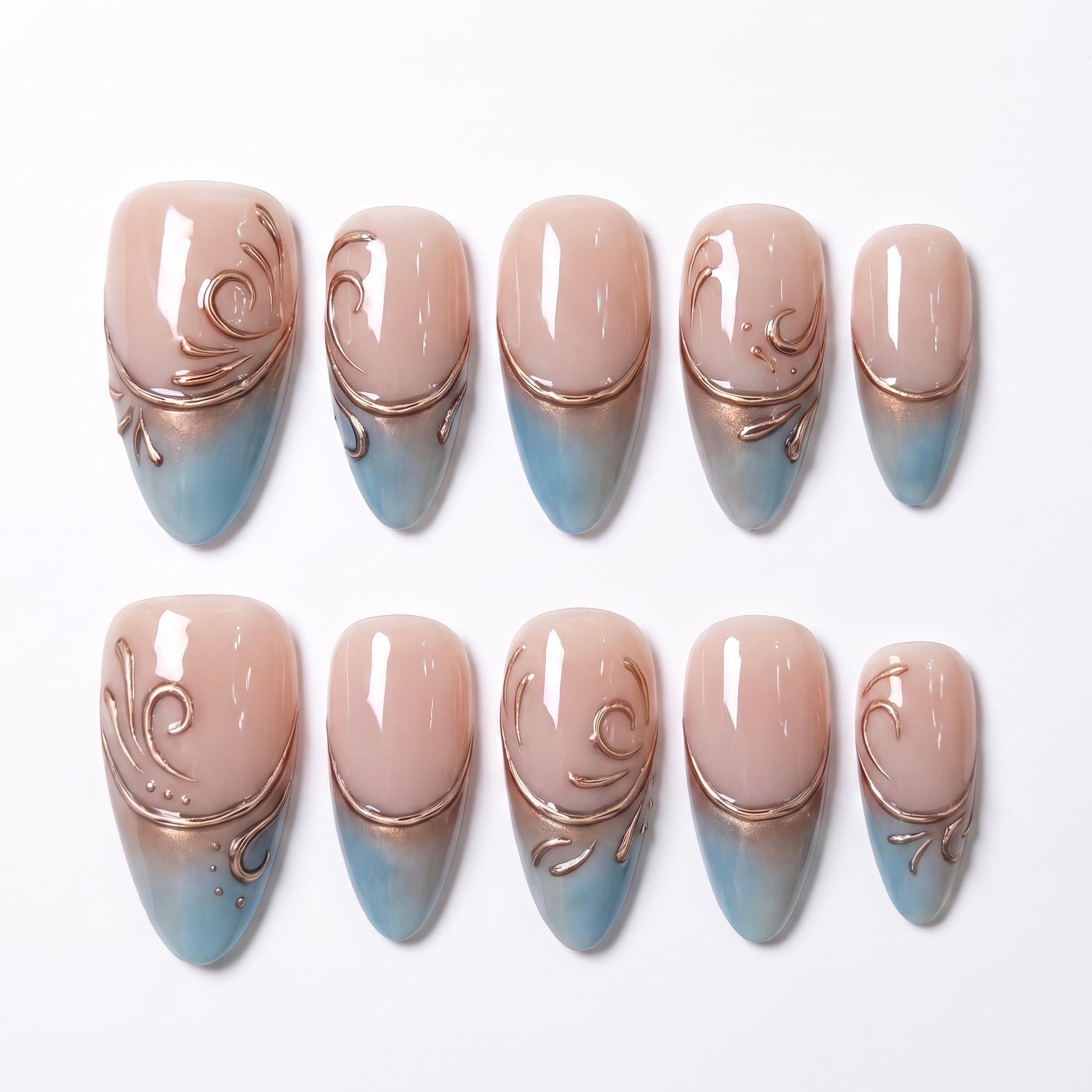 Duskwater Script handmade press-on nail set with nude bases, translucent blue tips, and flowing copper-gold swirl details by Nailsium