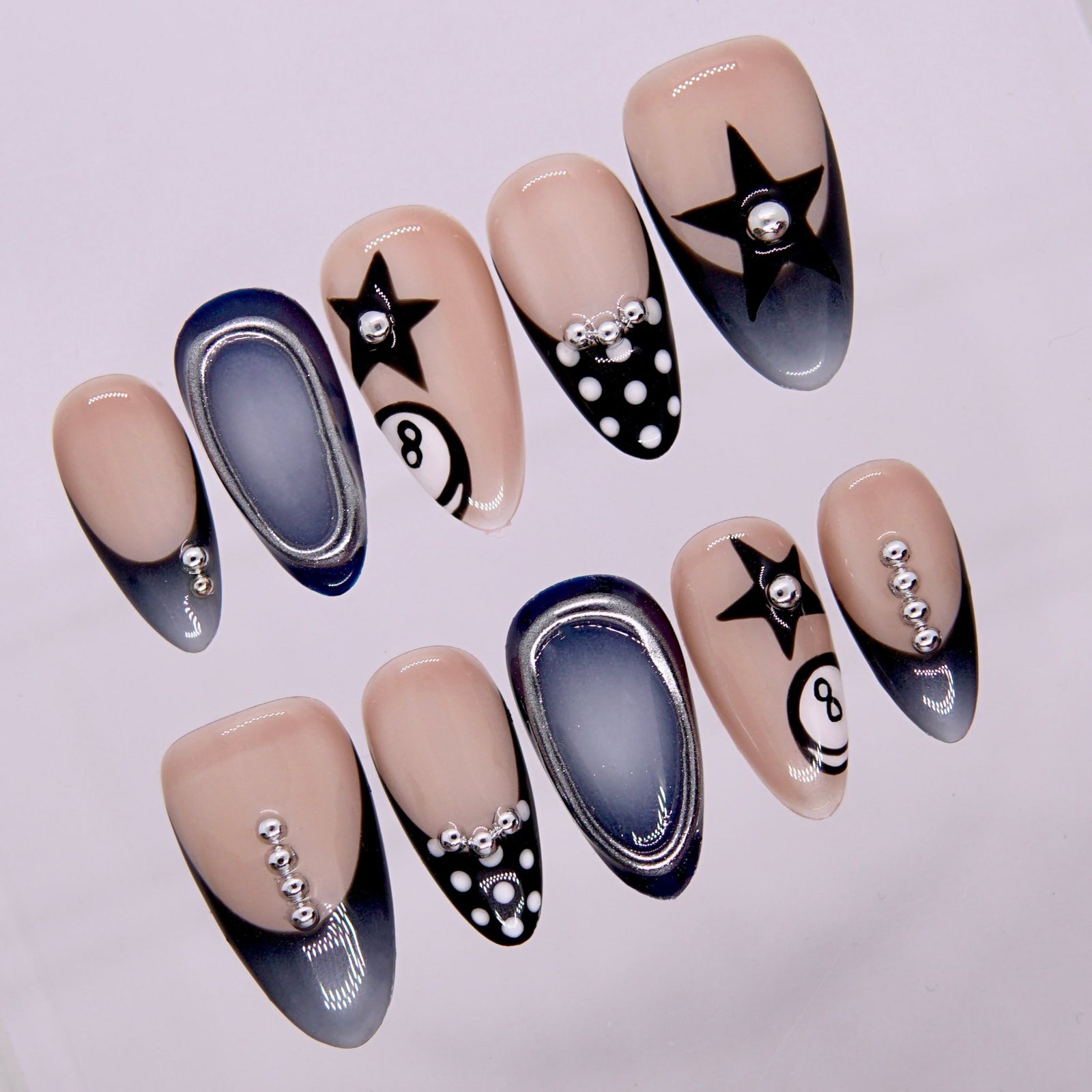 Close-up of Eight Ball Baby nails showing 8-ball motif and silver chrome outline.