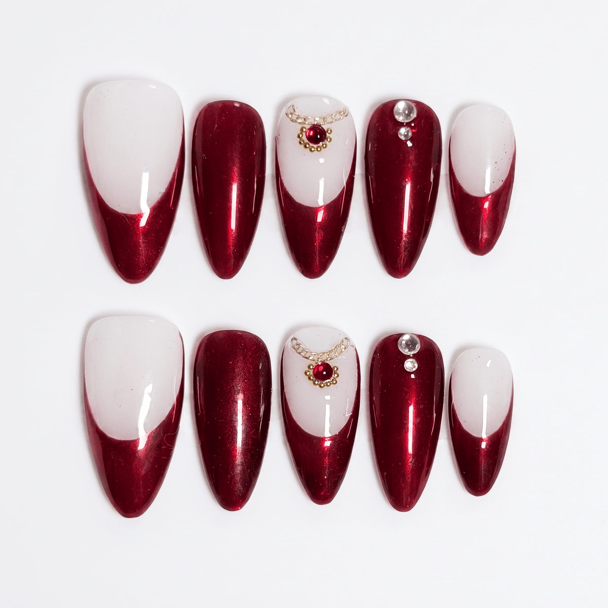 Snake zodiac press-on nails in deep wine red and ivory gradient with subtle gemstone accents representing Allure self love energy.

