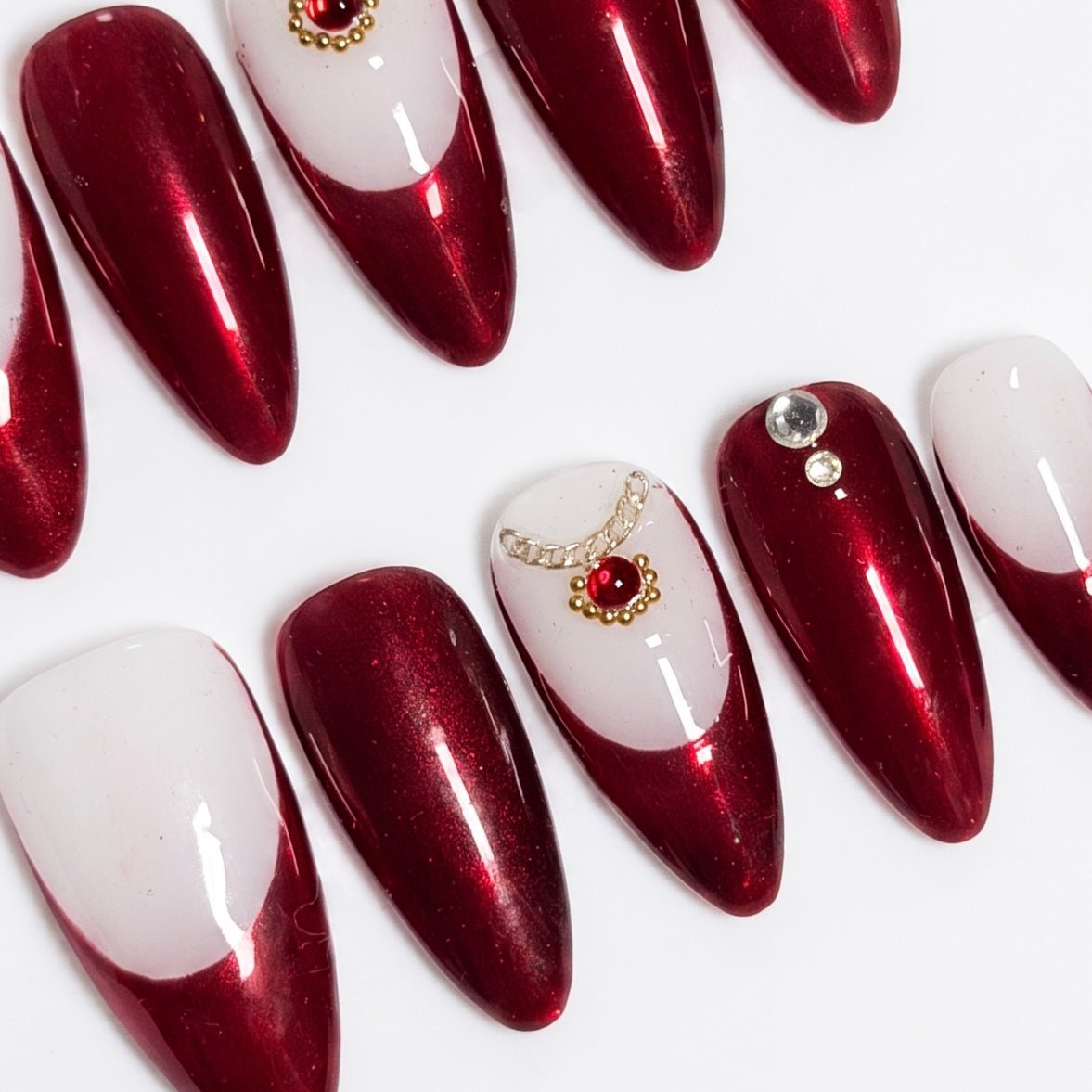 Close-up of Allure Snake press-on nails showing smooth red to ivory gradient and glossy finish.
