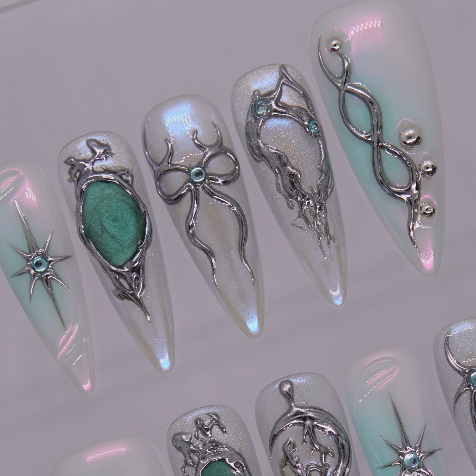 Iridescent surface reflecting silver-blue tones under light.