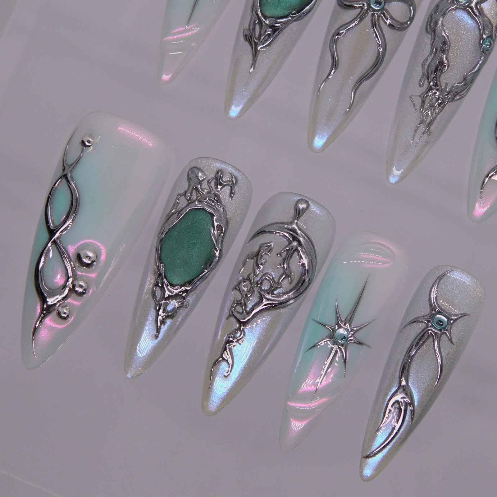 Iridescent surface reflecting silver-blue tones under light.