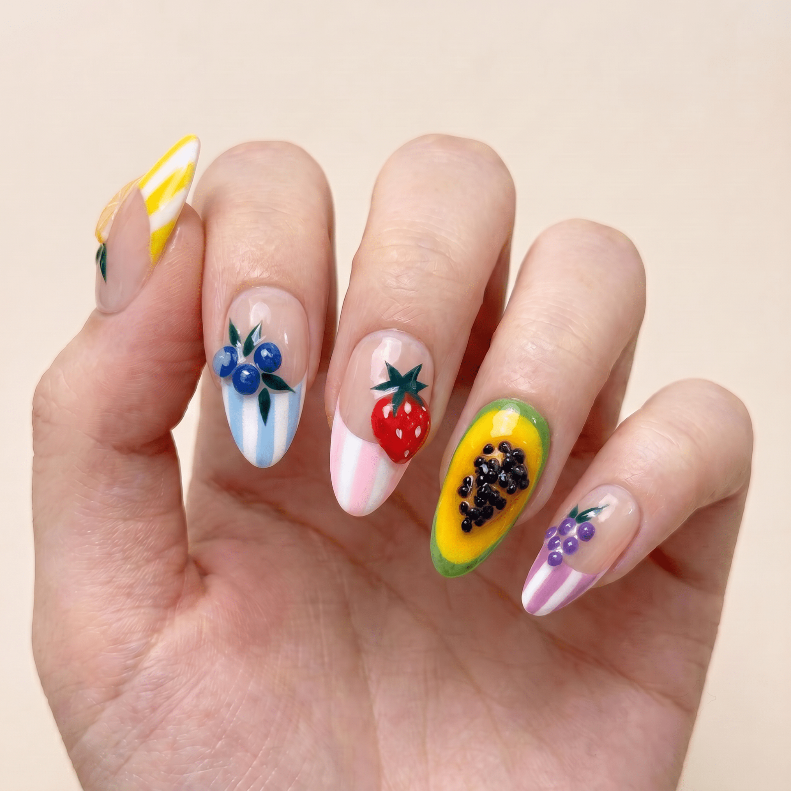 Colorful fruit press-on nails worn on hands by Nailsium