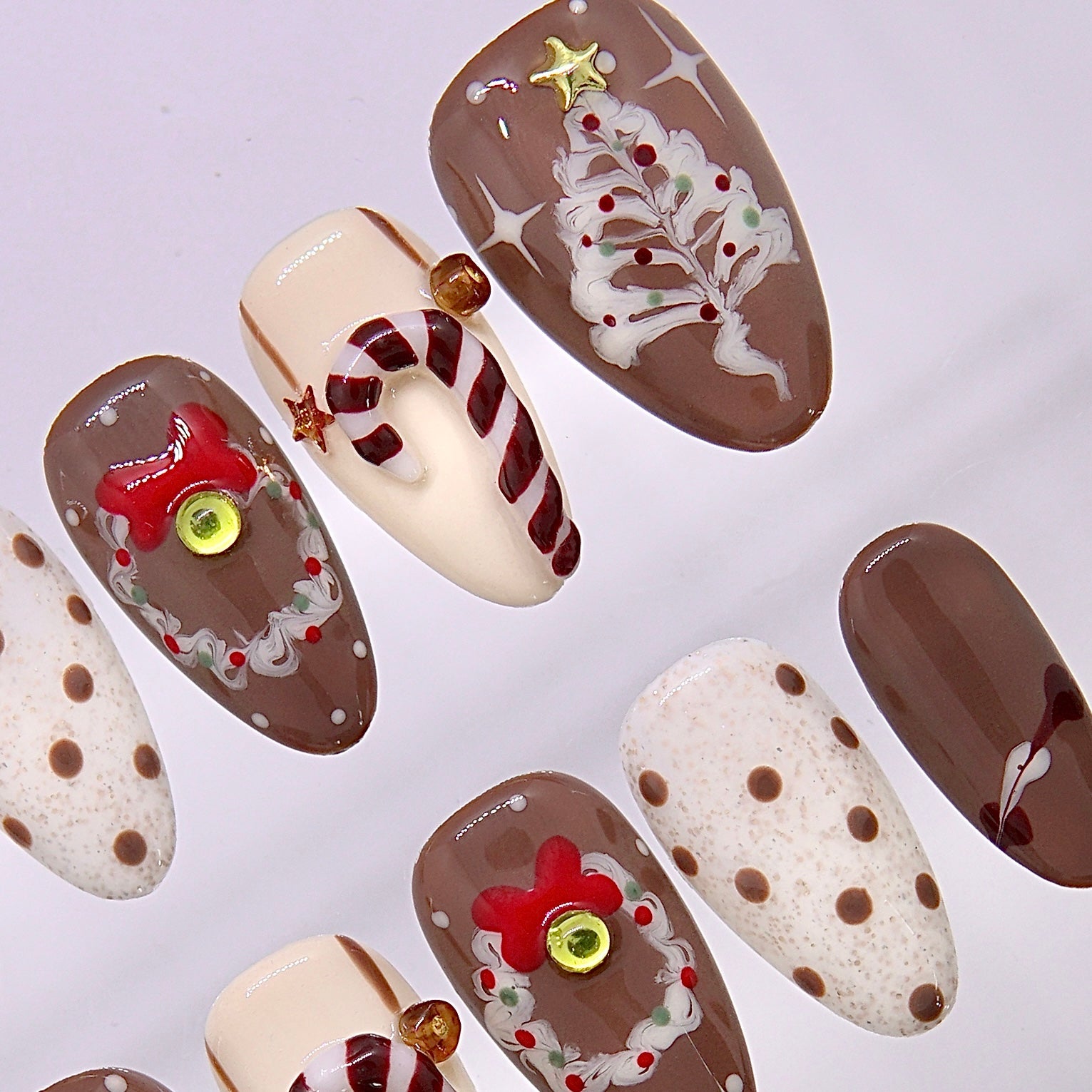 Holiday coffee inspired press on nails with cocoa tones tiny festive details and subtle sparkle.