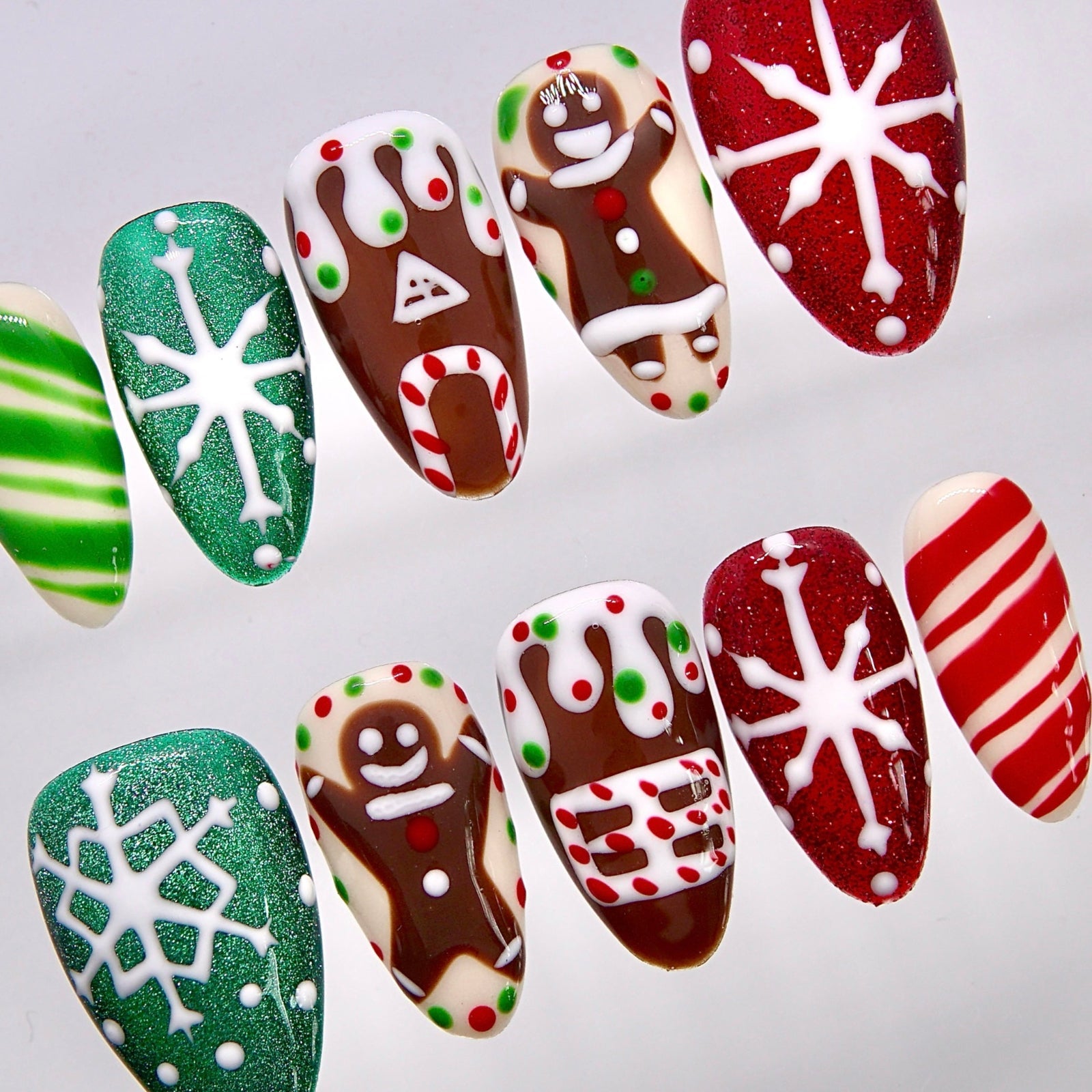 Close-up of gingerbread man and frosting-inspired Christmas nail art