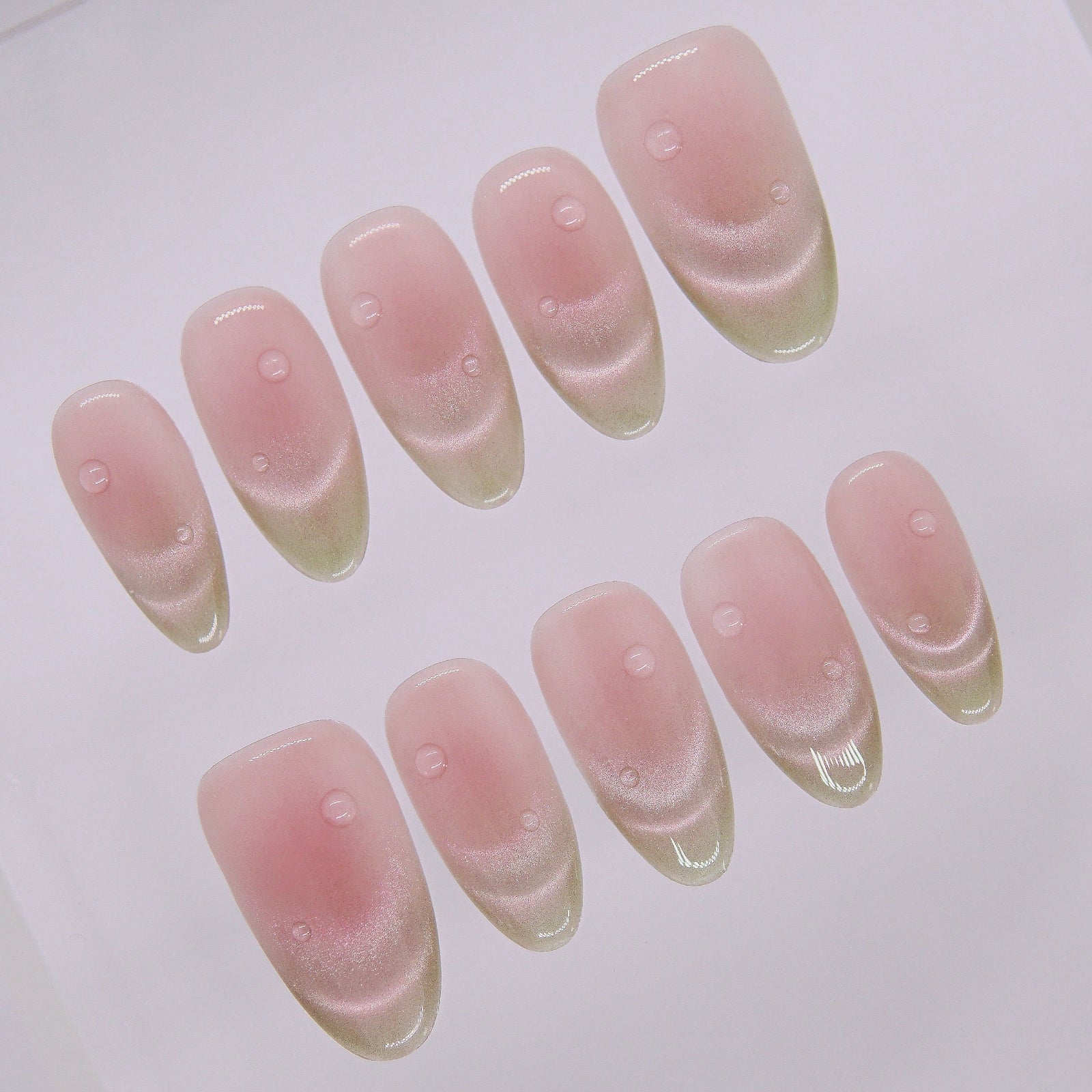 Side angle showing long oval jelly texture nails in red-green ombré with glazed finish.