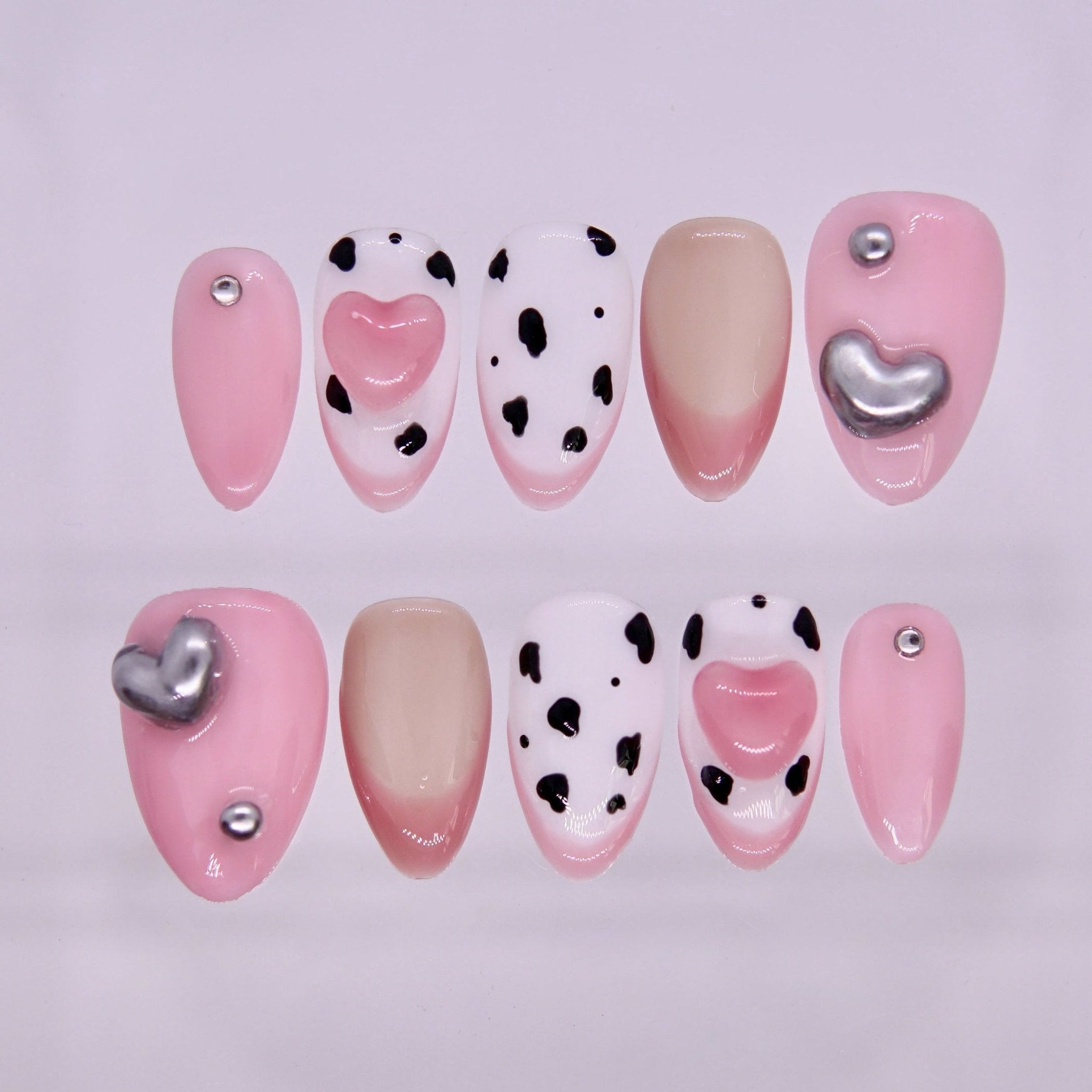Ox zodiac press-on nails in blush pink and nude tones with heart accents and silver details representing Haven self love energy.