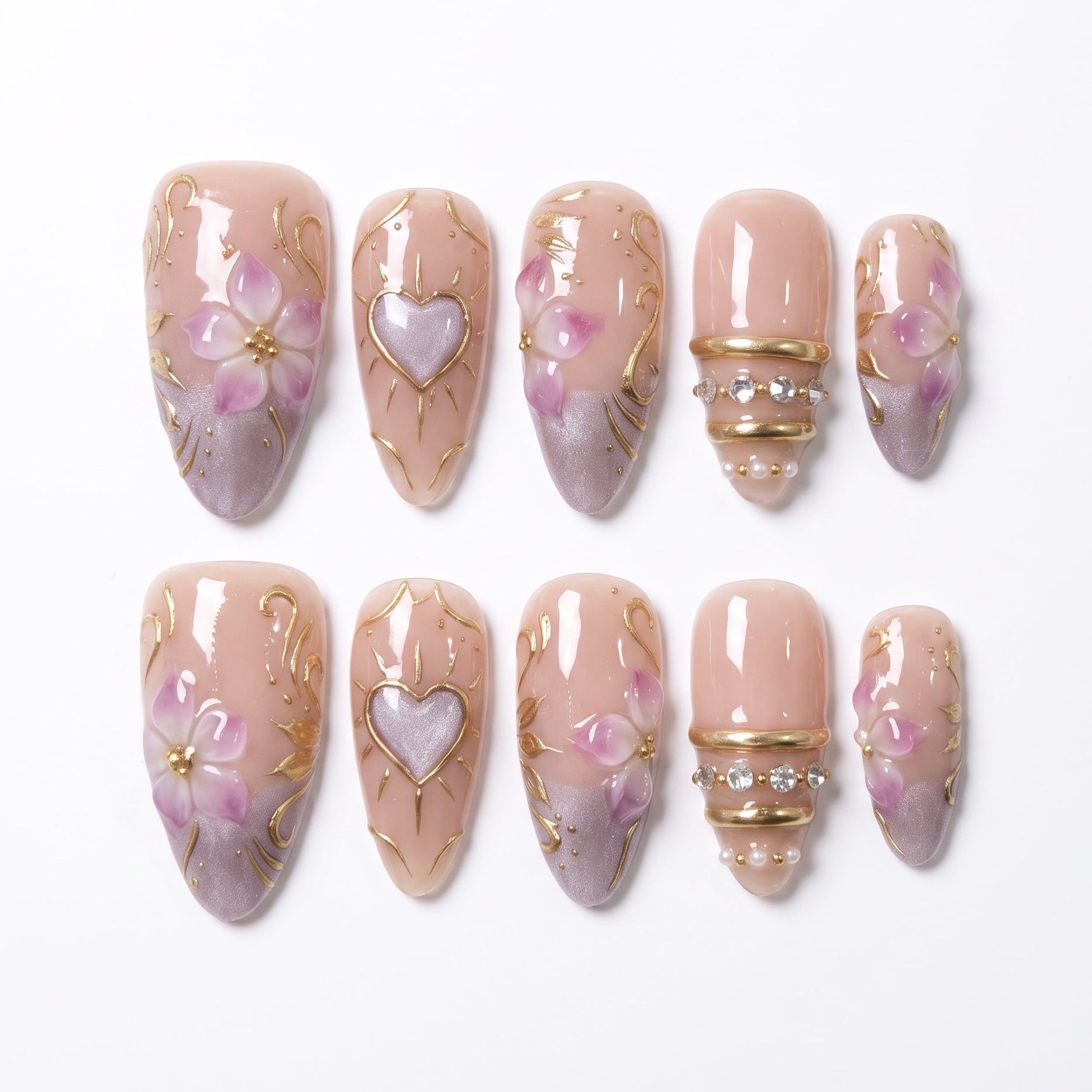 Heartspell Garden handmade press-on nail set with nude bases, lilac flowers, heart accents, sculpted gold vines, and crystal details by Nailsium