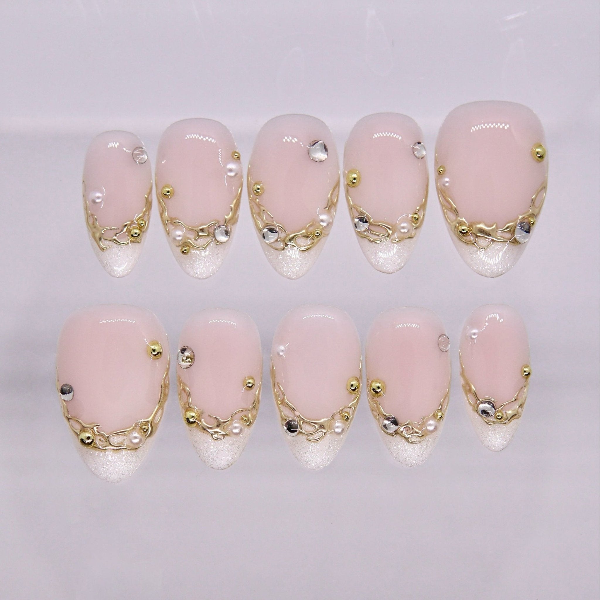 Nude press on nails with gold accents and clean minimalist design