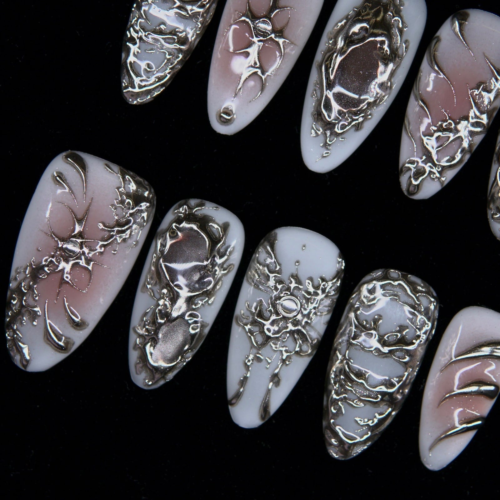 Hand-sculpted silver patterns evoking slow corrosion and rebirth.