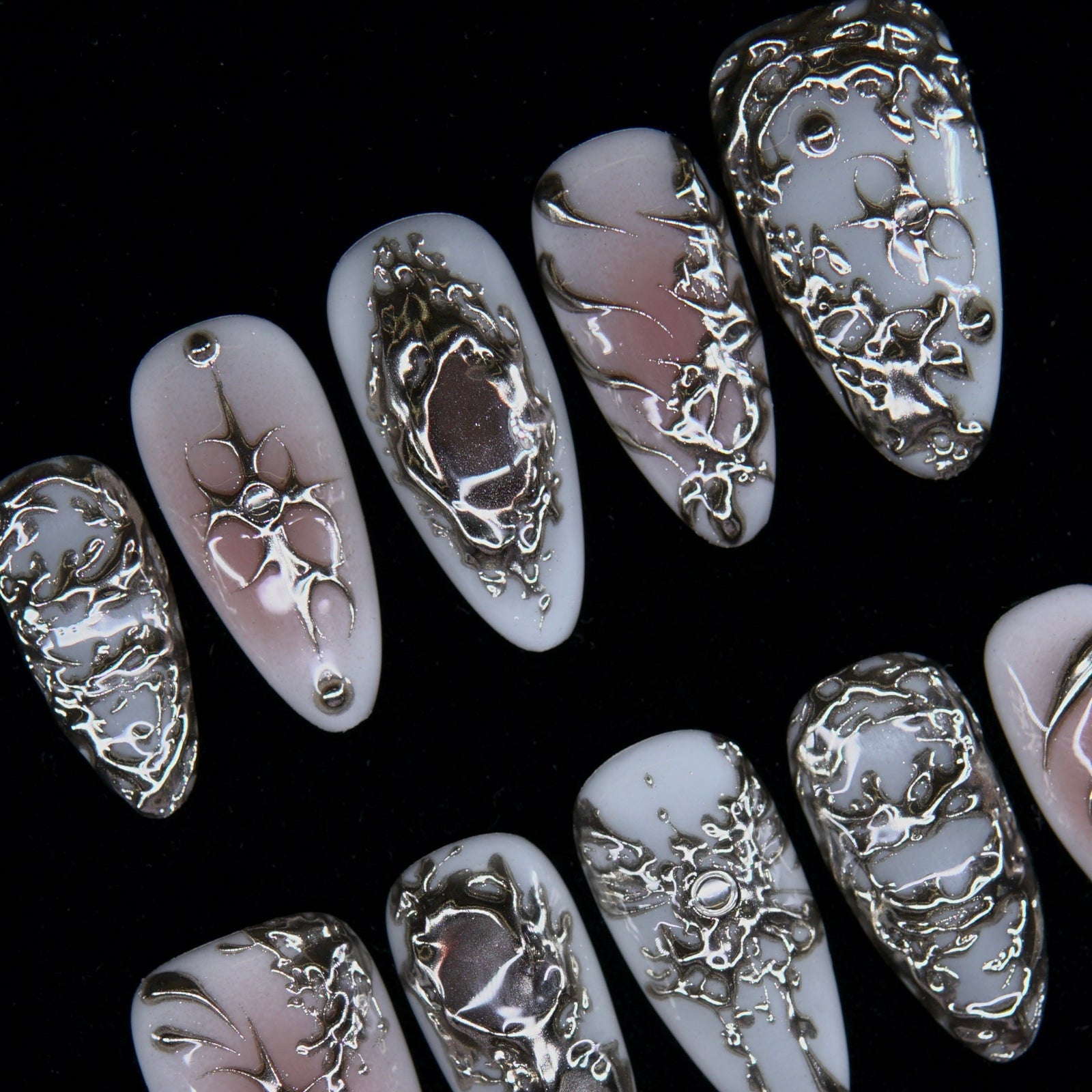Hand-sculpted silver patterns evoking slow corrosion and rebirth.