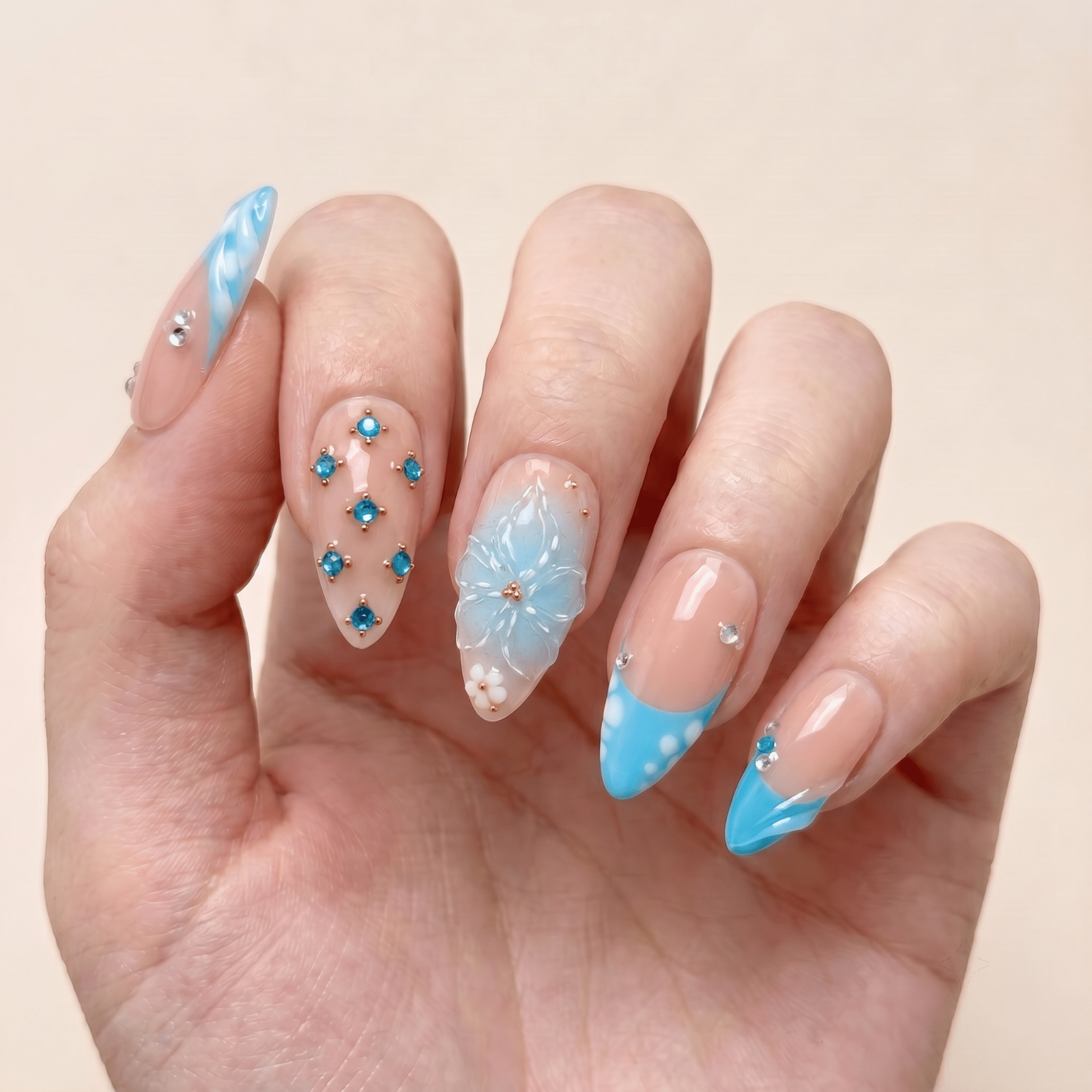 Pink floral press-on nails worn on hands by Nailsium