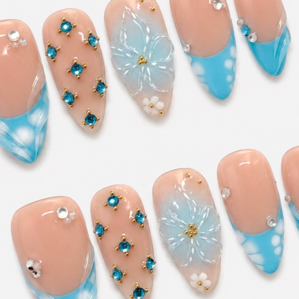 Hand painted pink floral press-on nails with pearl and seashell accents by Nailsium