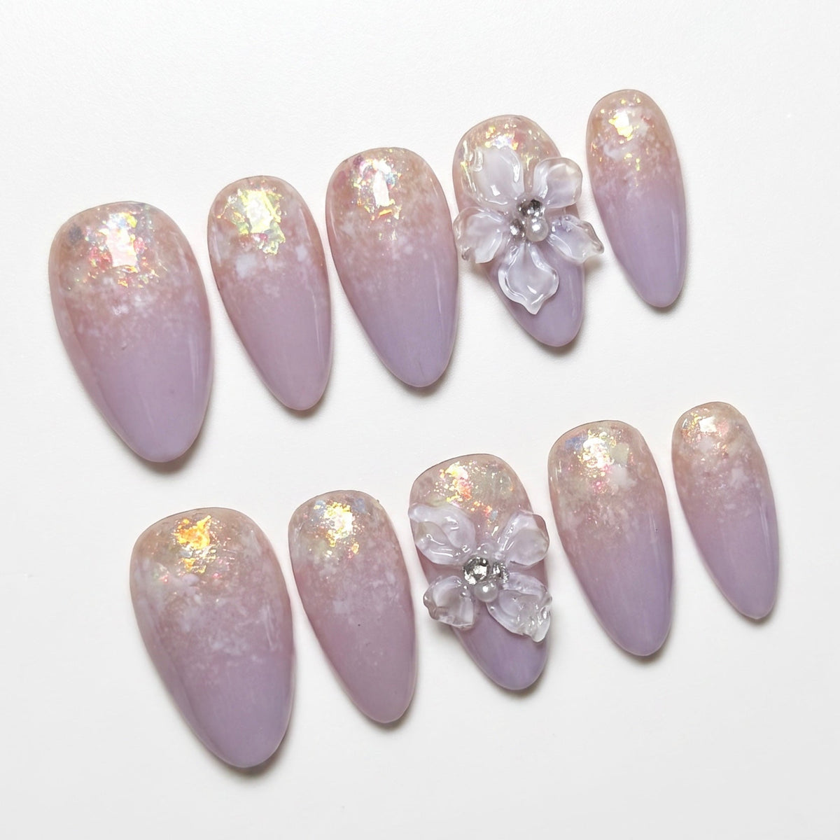 Detailed view of lavender ombré gradient with iridescent flakes on press-on nails.