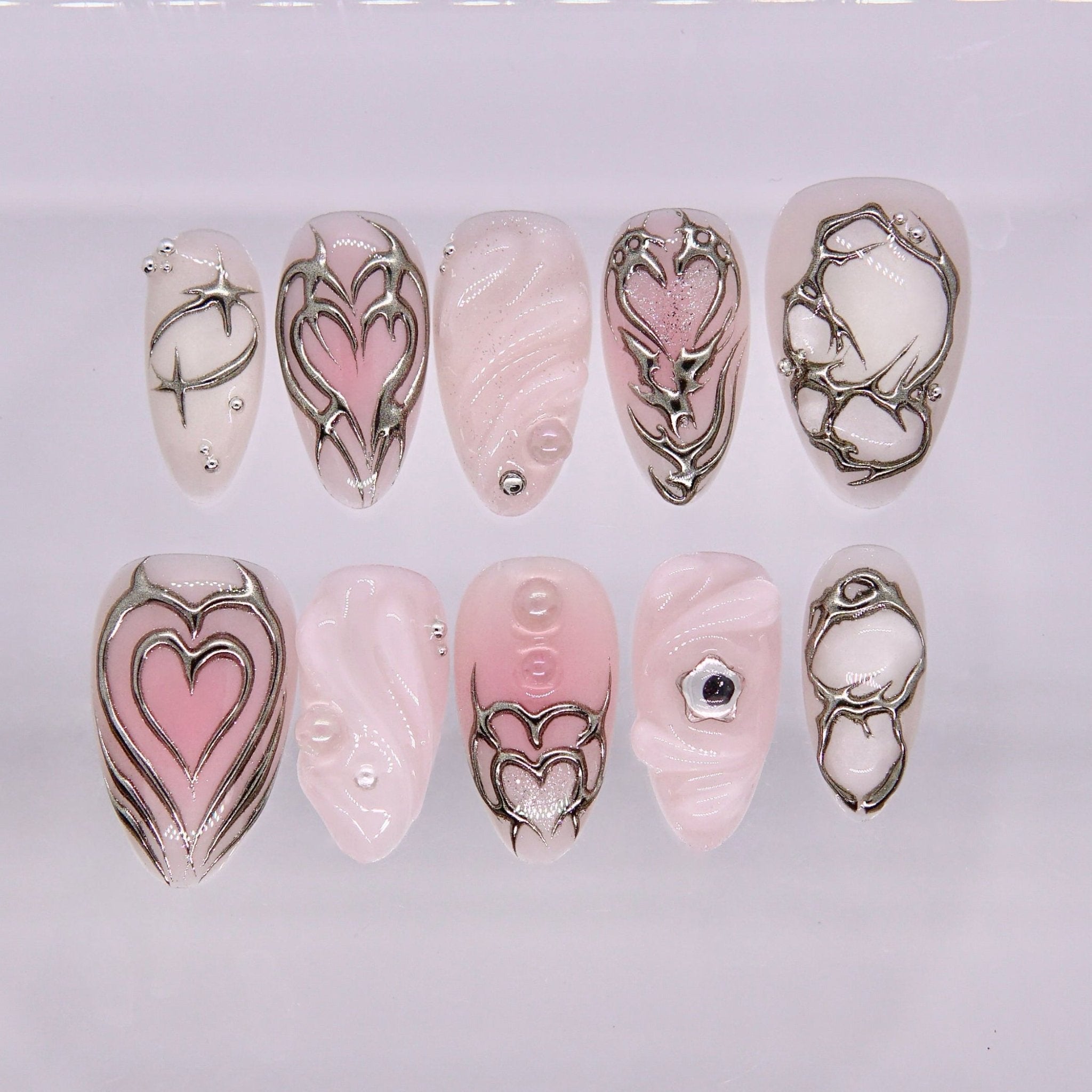 Soft pink heart themed press on nails with silver chrome details