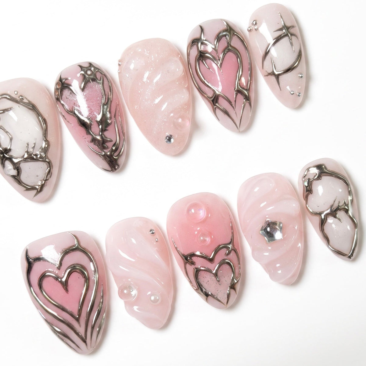 Chrome heart frame nail art with glossy pink base
