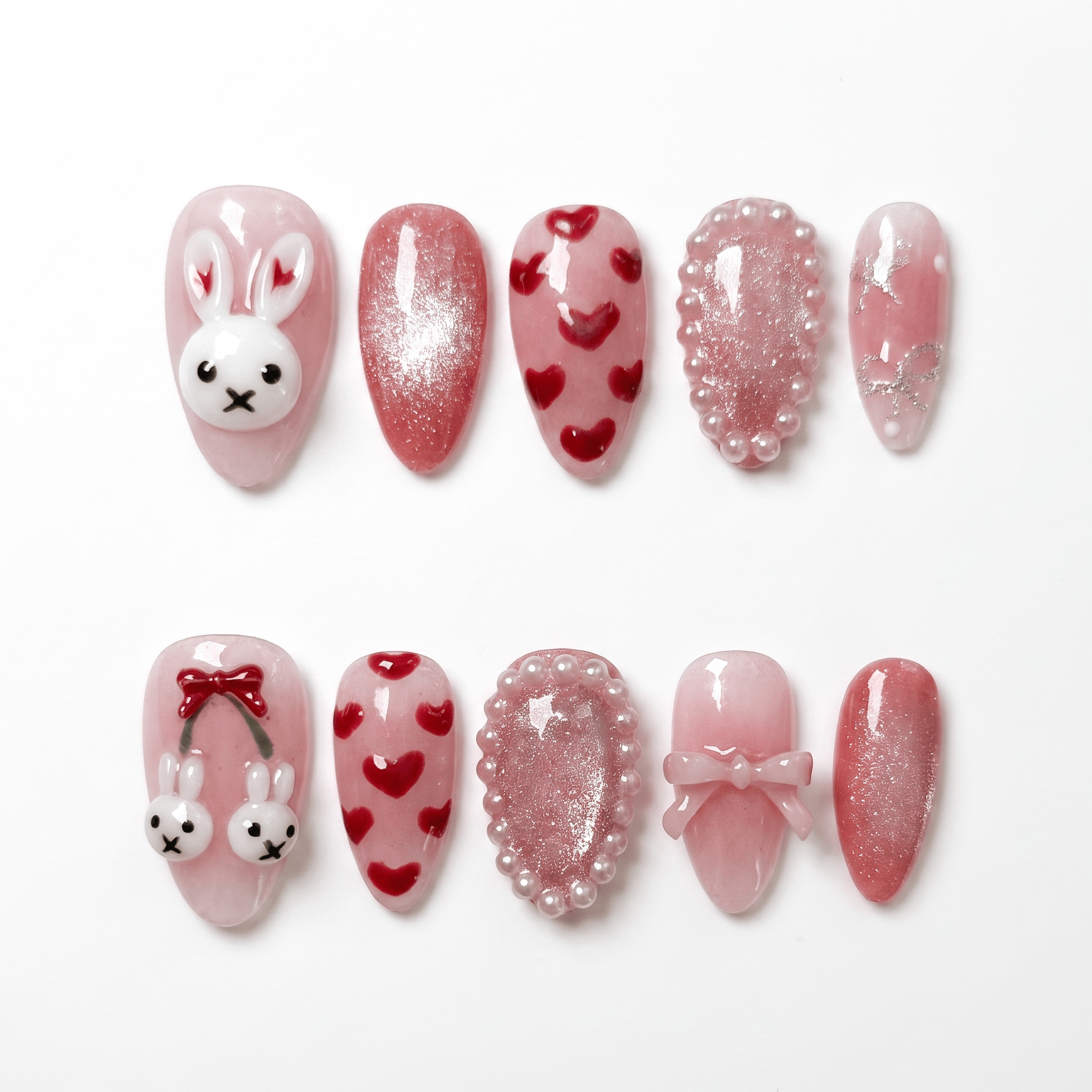 Rabbit zodiac press-on nails in blush pink with shimmer finish, heart patterns, pearl accents, bows, and bunny charms representing Lullaby and gentle self love.