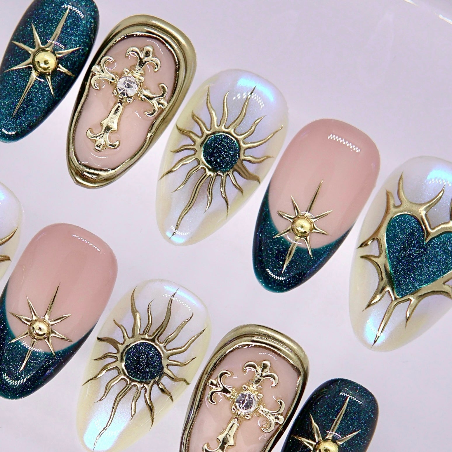 Celestial nail art with metallic gold lines and glossy finish