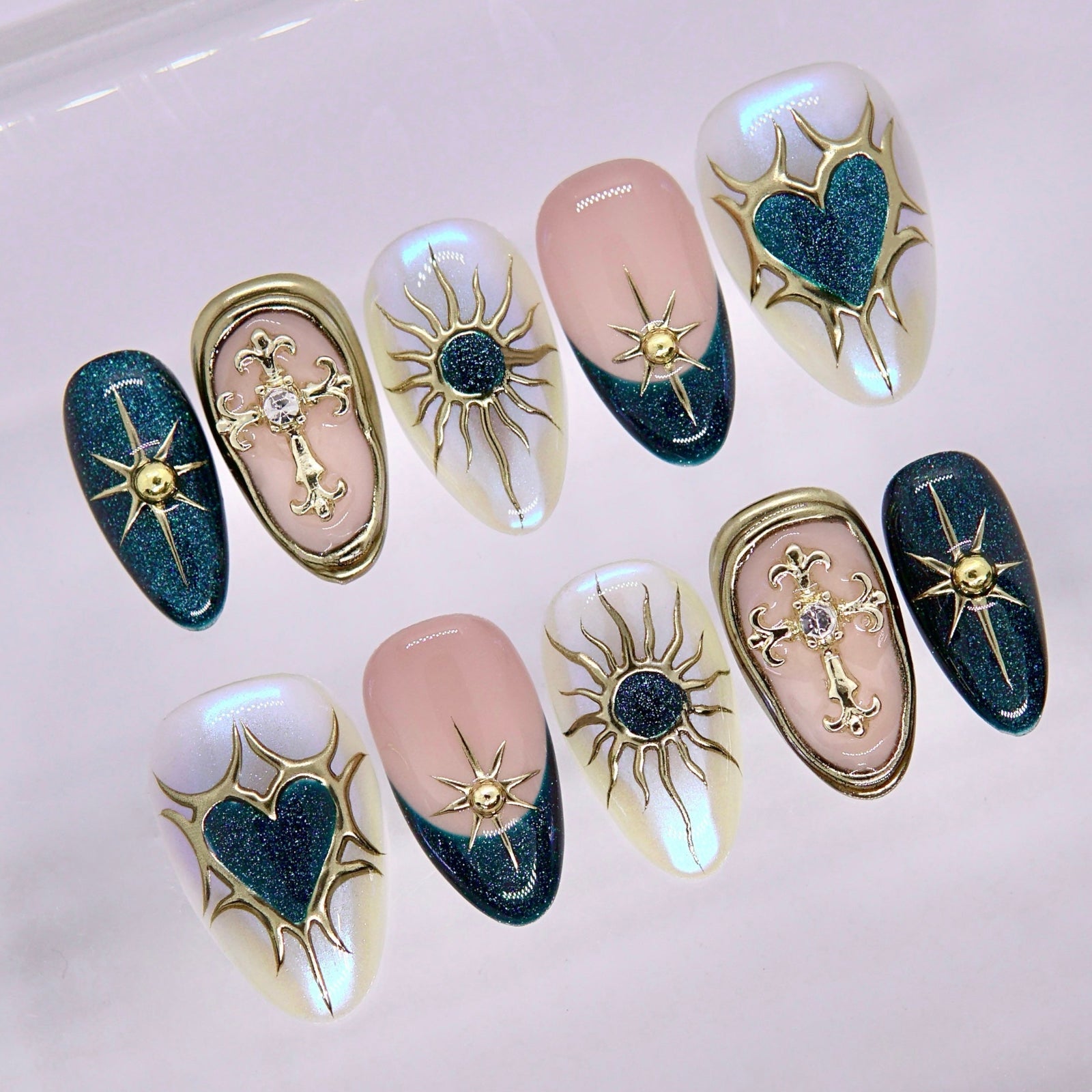 Close-up of deep blue nails with gold star and symbol accents