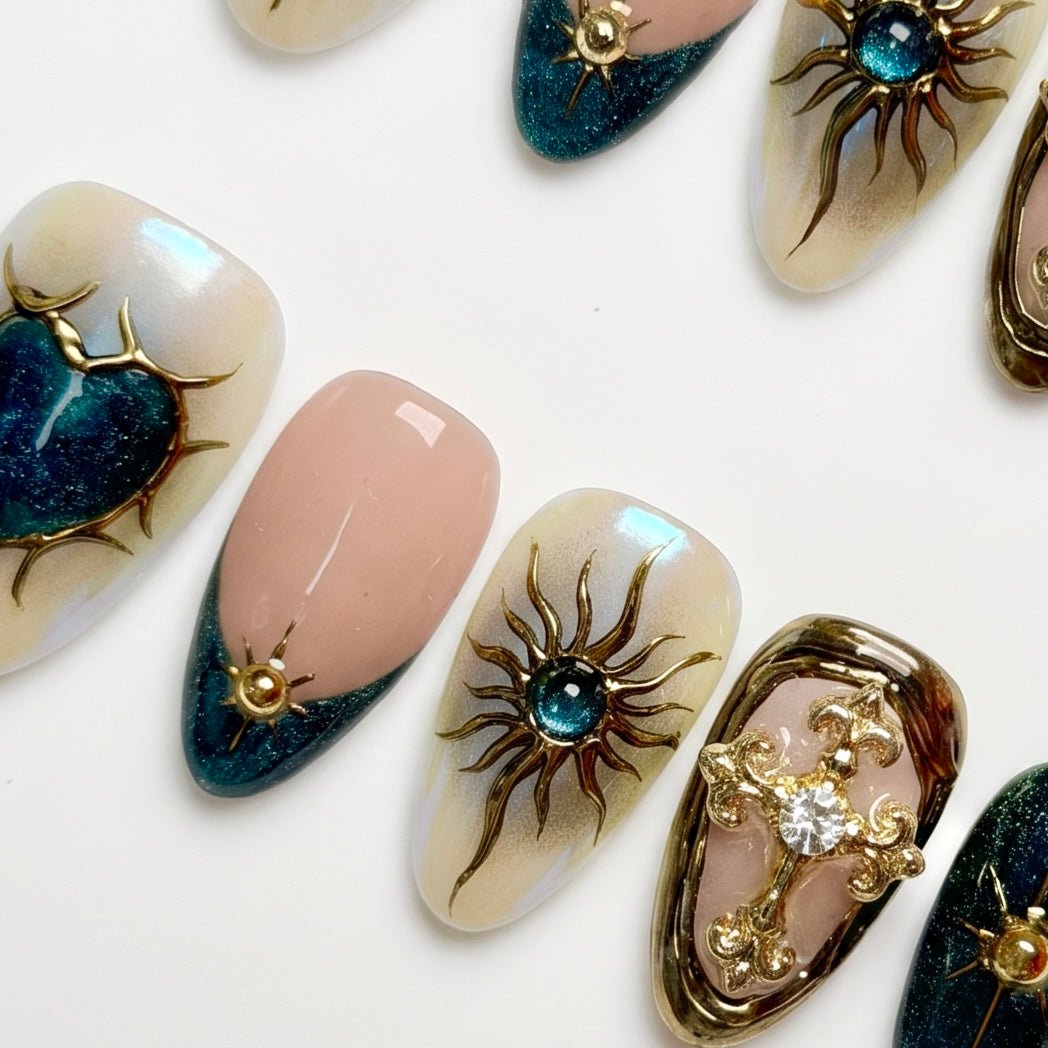 Close-up of deep blue nails with gold star and symbol accents