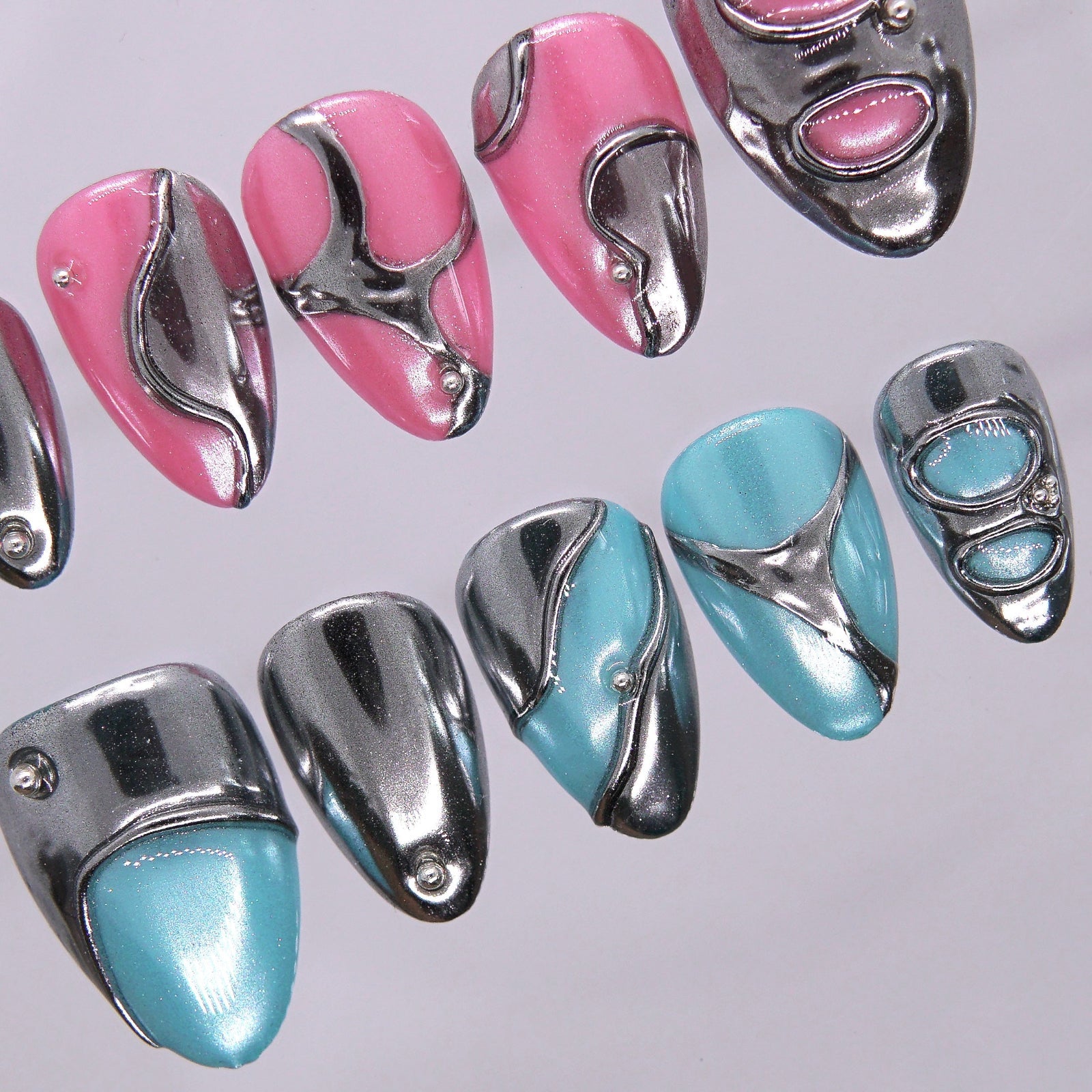 Close-up of Mirror Error press-on nails showing blue and pink split tones.