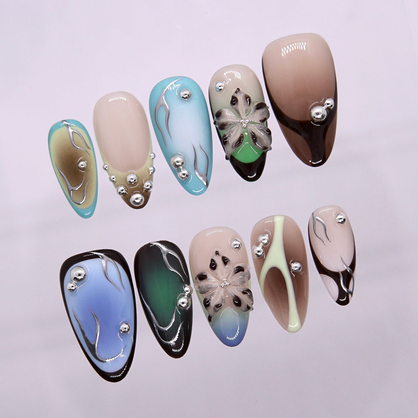 Close-up of metallic bead accents on neon nail.
