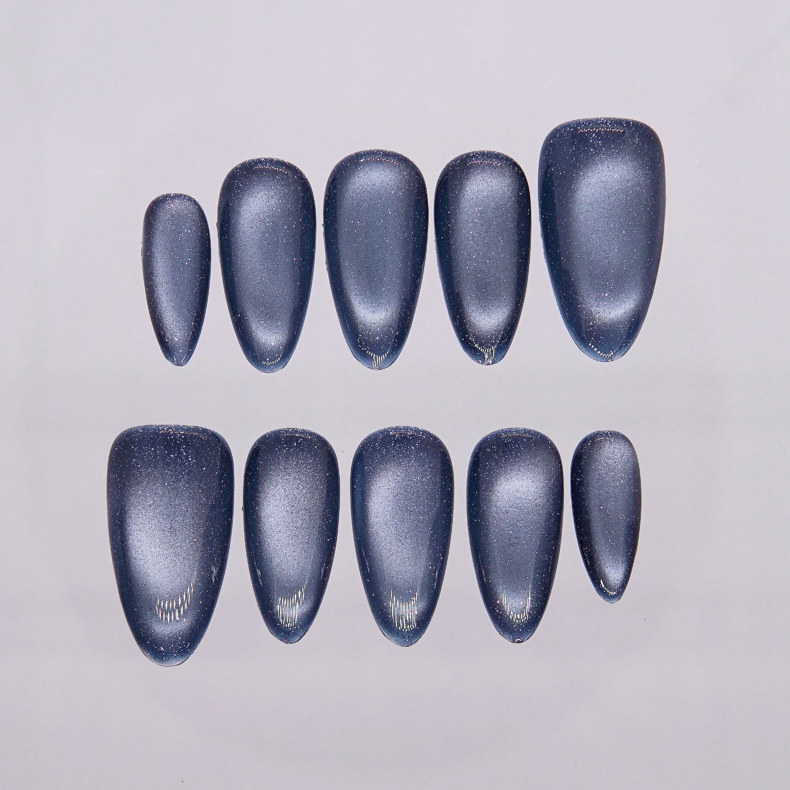 Close-up of shimmering blue-gray cat eye effect on Night Steel nails.