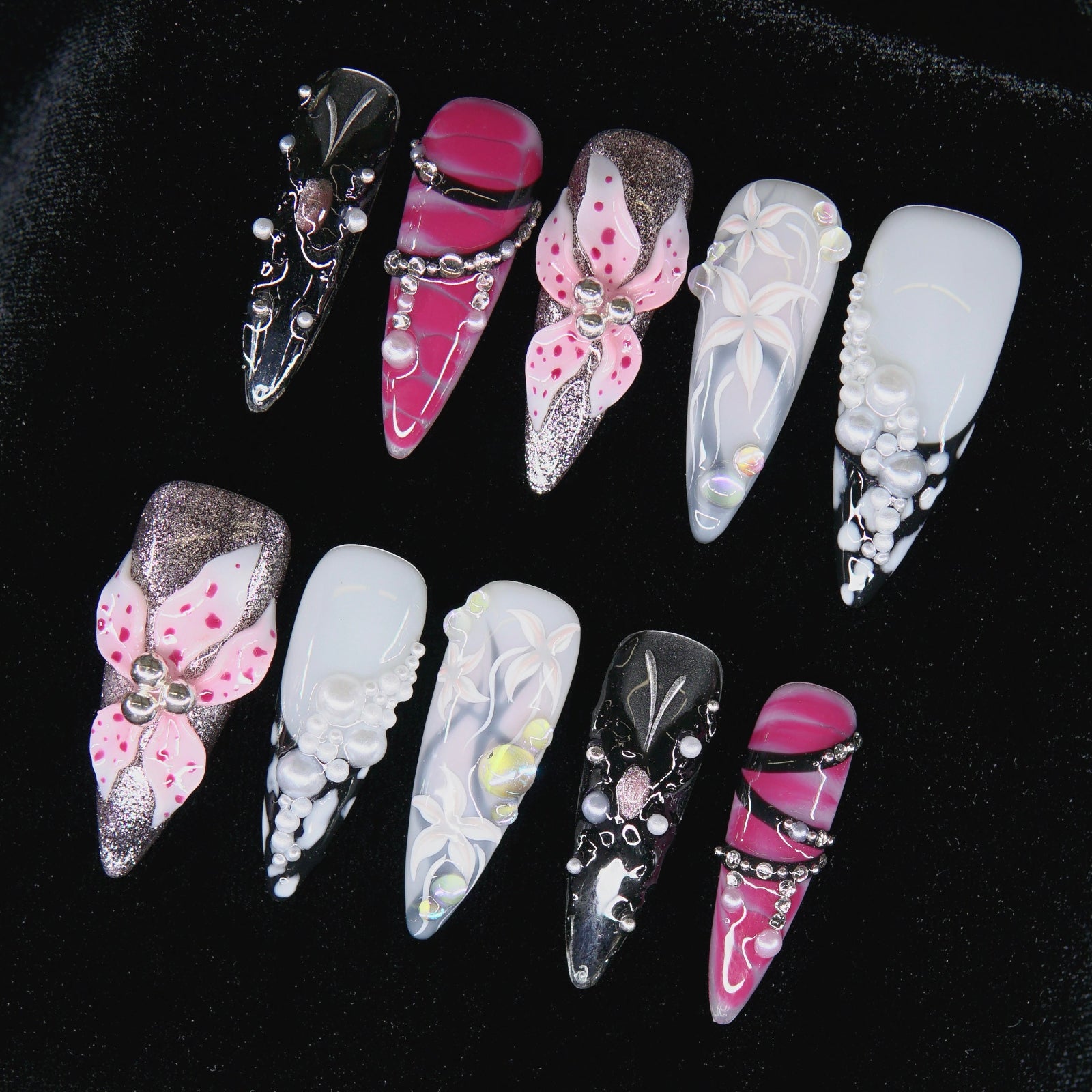 Close-up of handcrafted pearl and flower textures on Obsidian Bloom nails.
