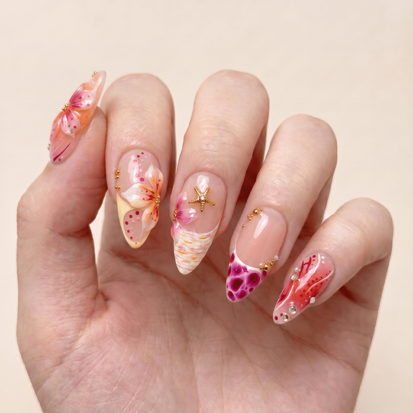 Pink tropical press-on nails worn on hands by Nailsium