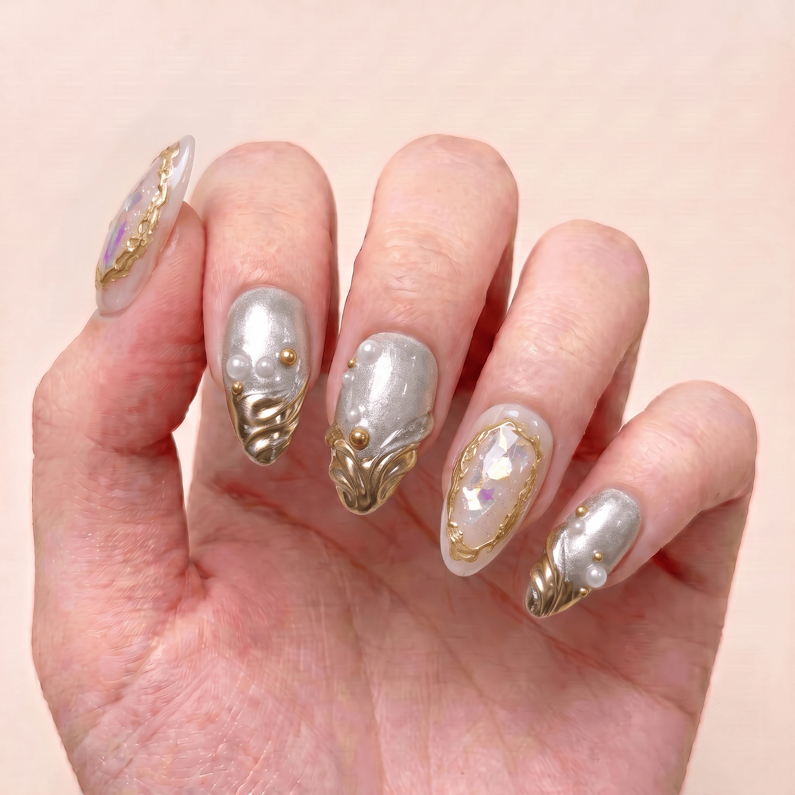 Pearl Reliquary handmade press-on nails worn on hand, featuring silver shimmer, pearl accents, antique gold details, and a jewelry-inspired finish