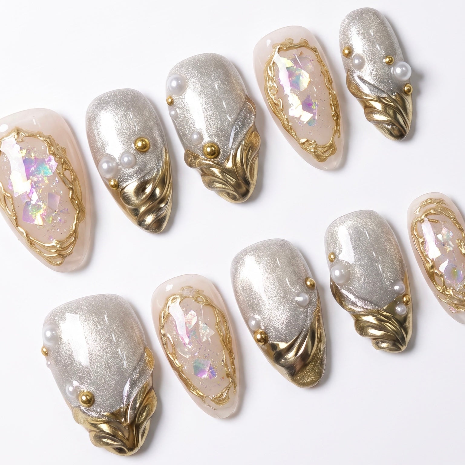 Close-up of Pearl Reliquary press-on nails featuring luminous pearls, dimensional gold detailing, silver shimmer, and iridescent foil accents