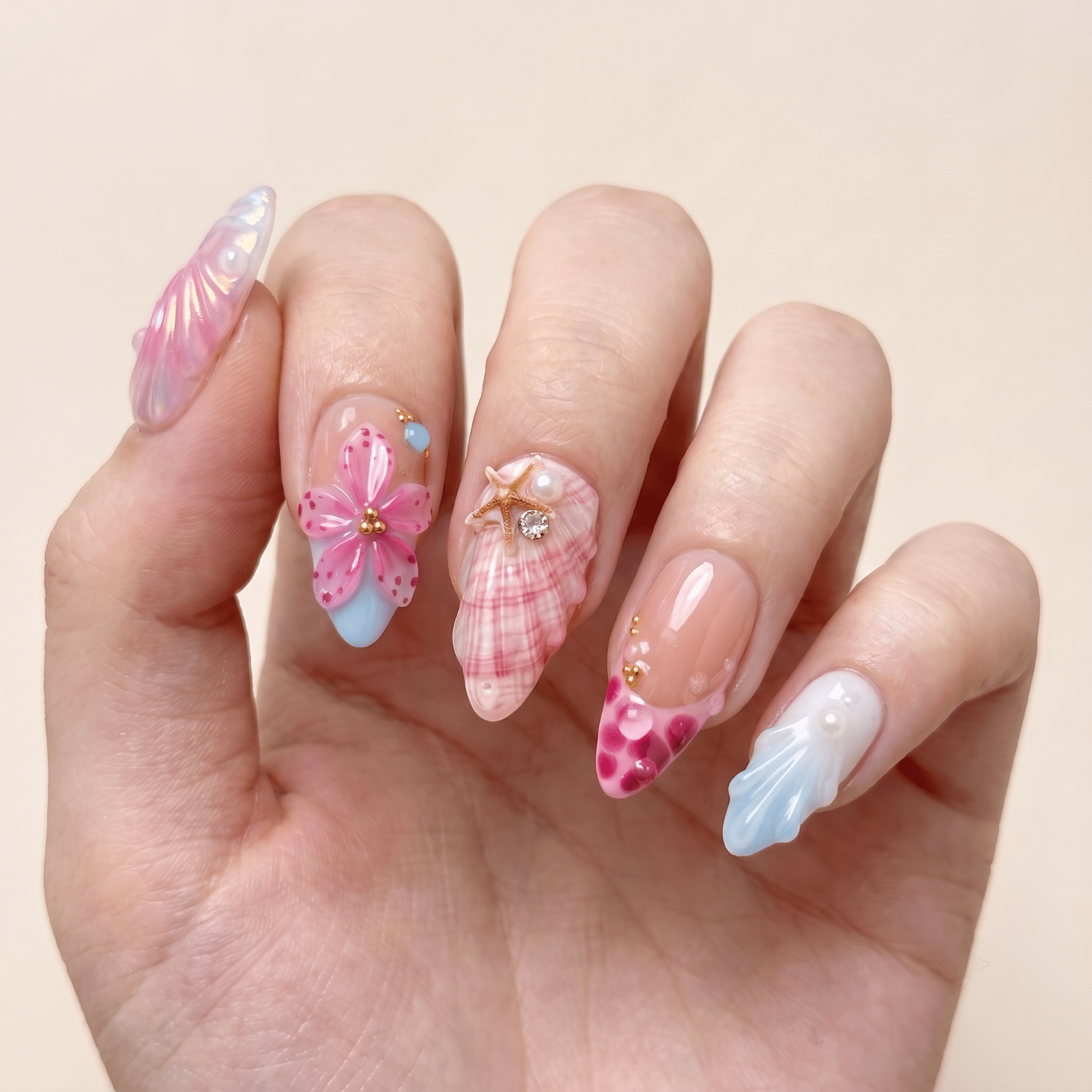 Pink floral press-on nails worn on hands by Nailsium