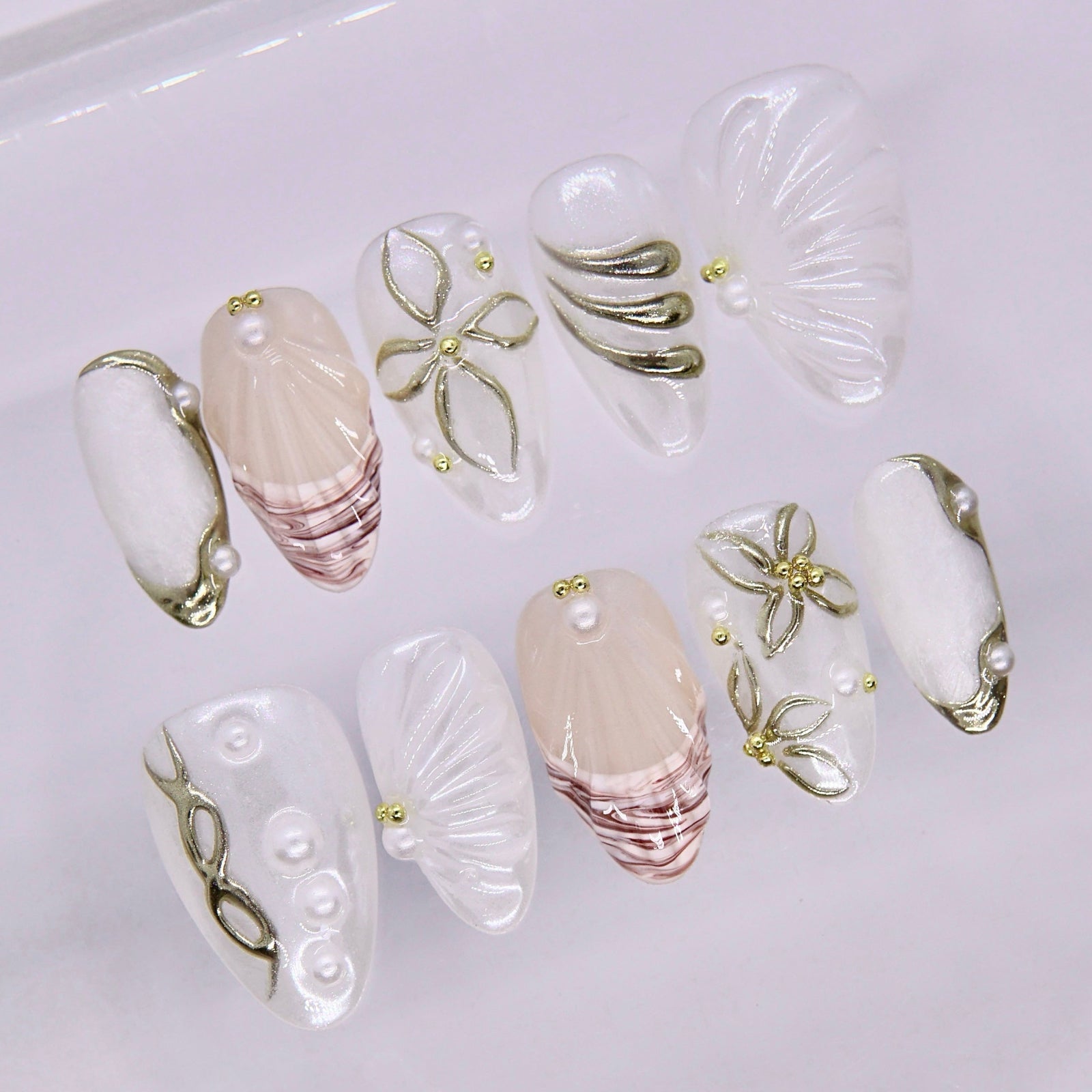 Seashell texture nail art with glossy pearl finish