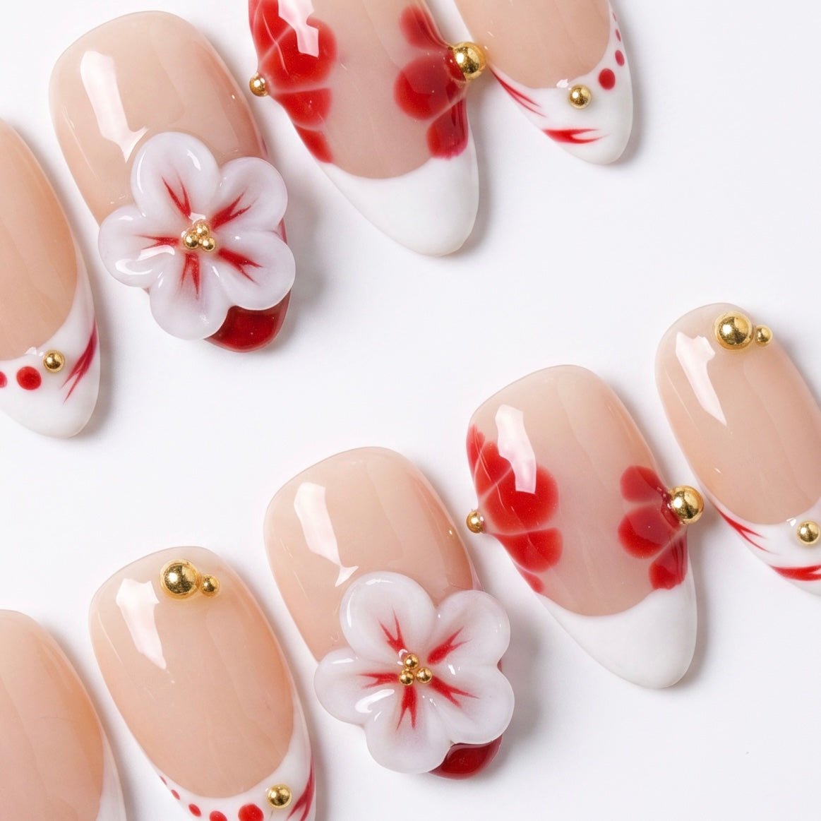 Sheer nude press-on nails featuring watercolor floral patterns and 3D flowers
