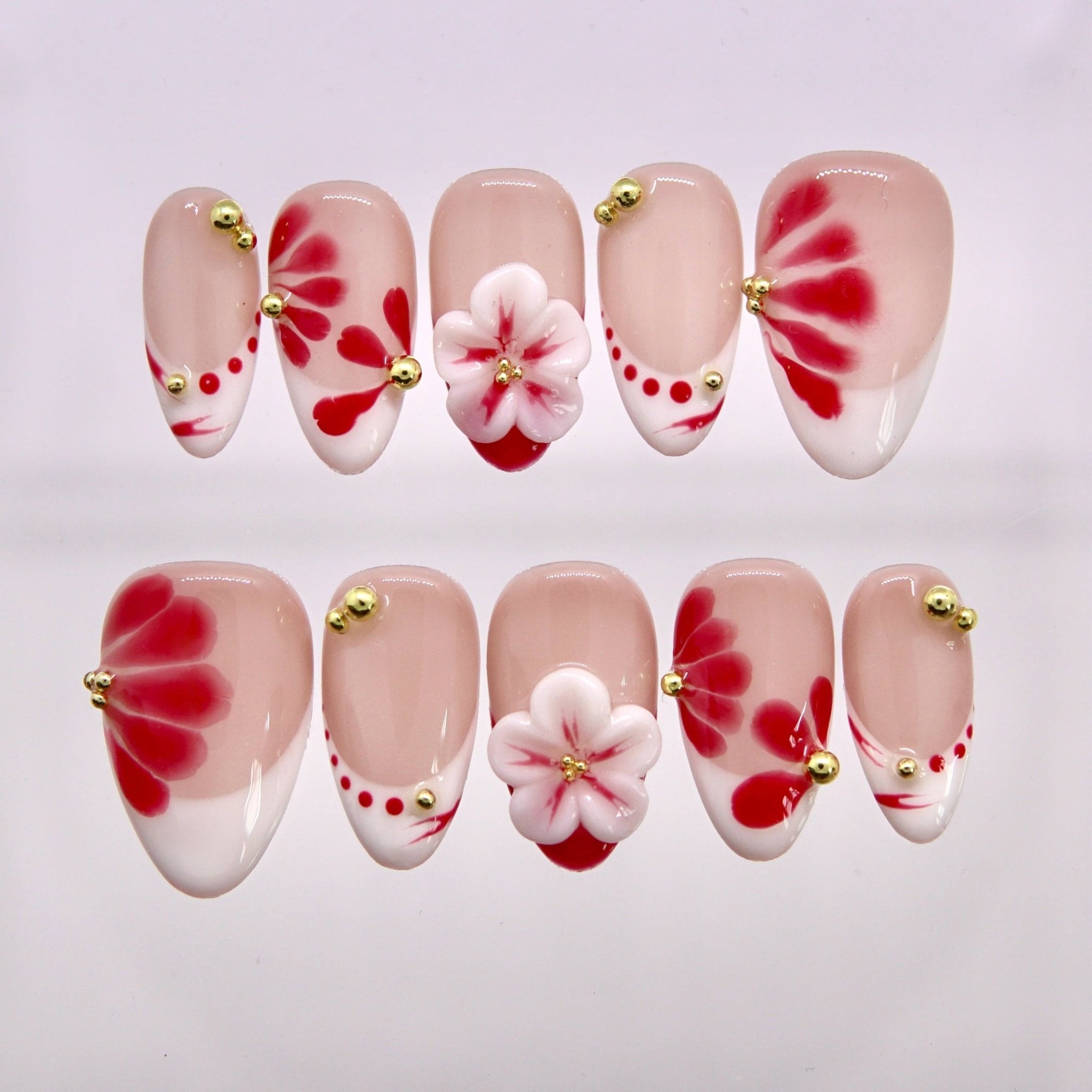 Petal Trace press-on nails with red petal designs and hand-sculpted floral accents