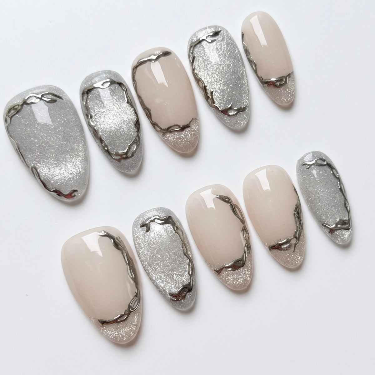 Nude press on nails with soft metallic accents and minimal design
