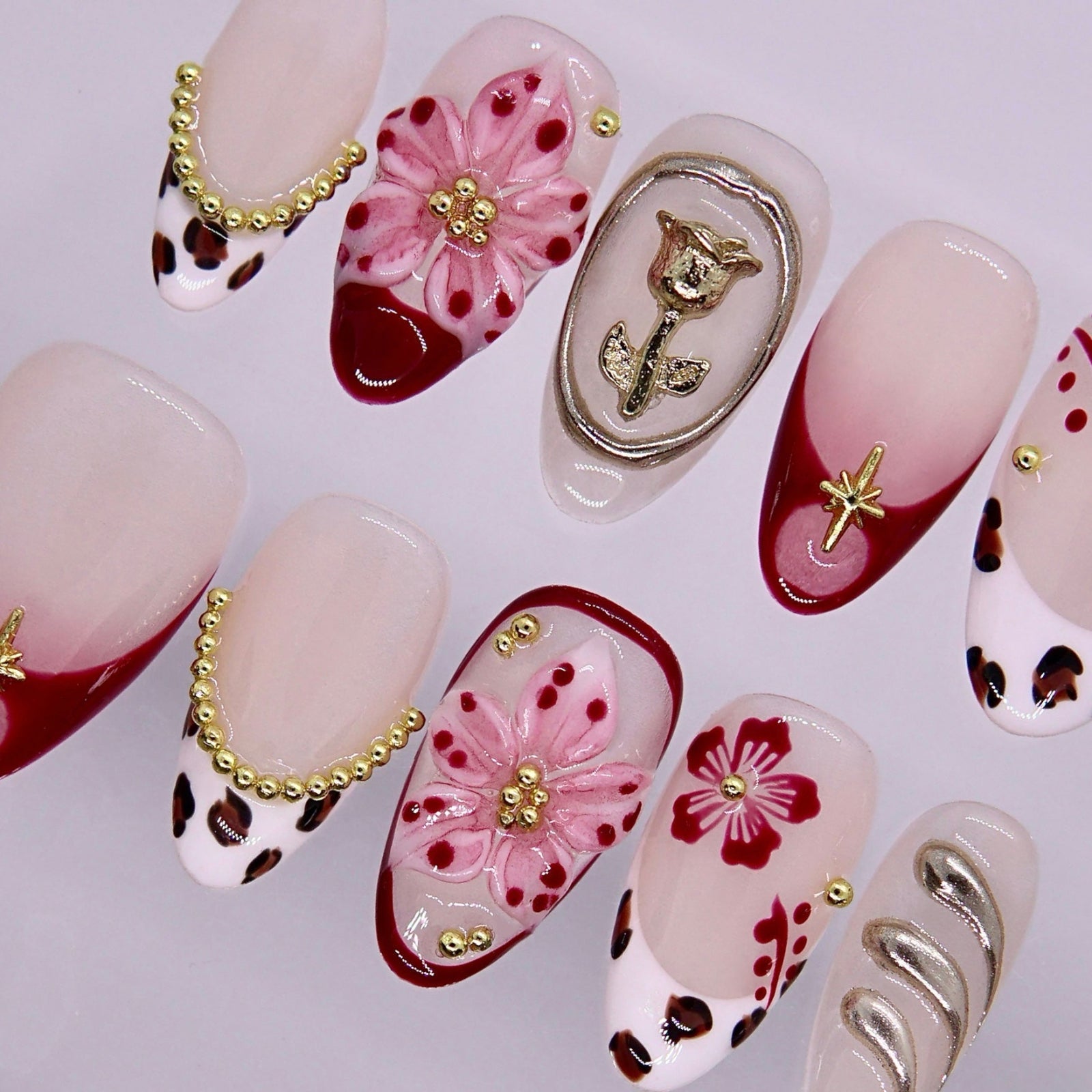 Mixed design nails featuring leopard print, floral patterns, and glossy finish