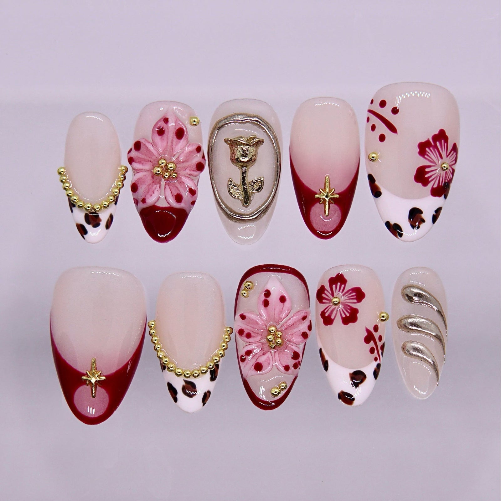 Red gradient press on nails with floral design, leopard print accents, and gold details