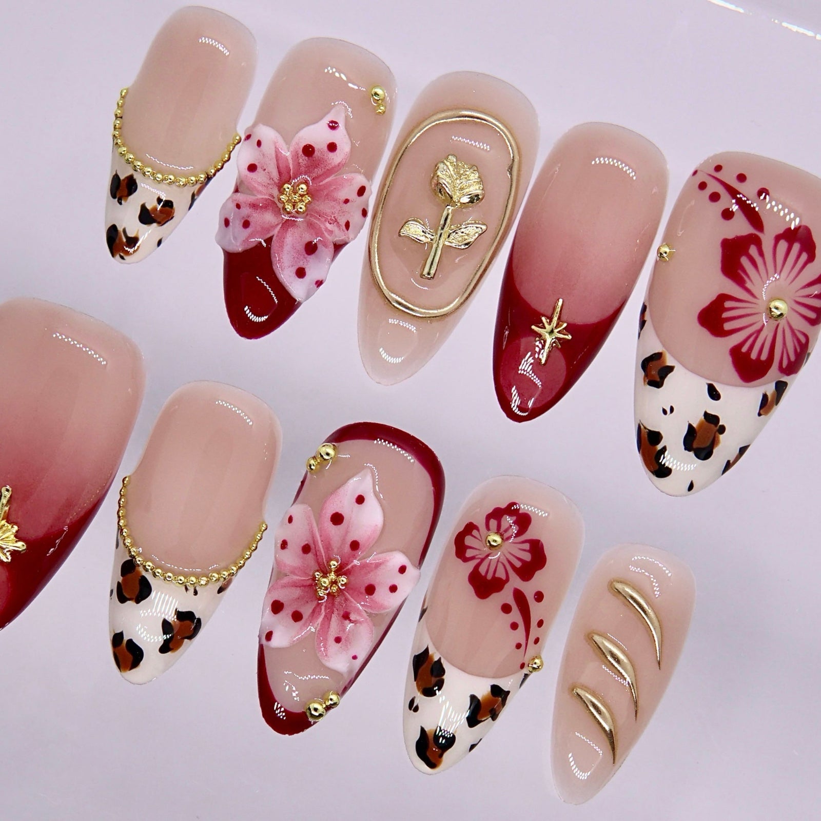 Mixed design nails featuring leopard print, floral patterns, and glossy finish