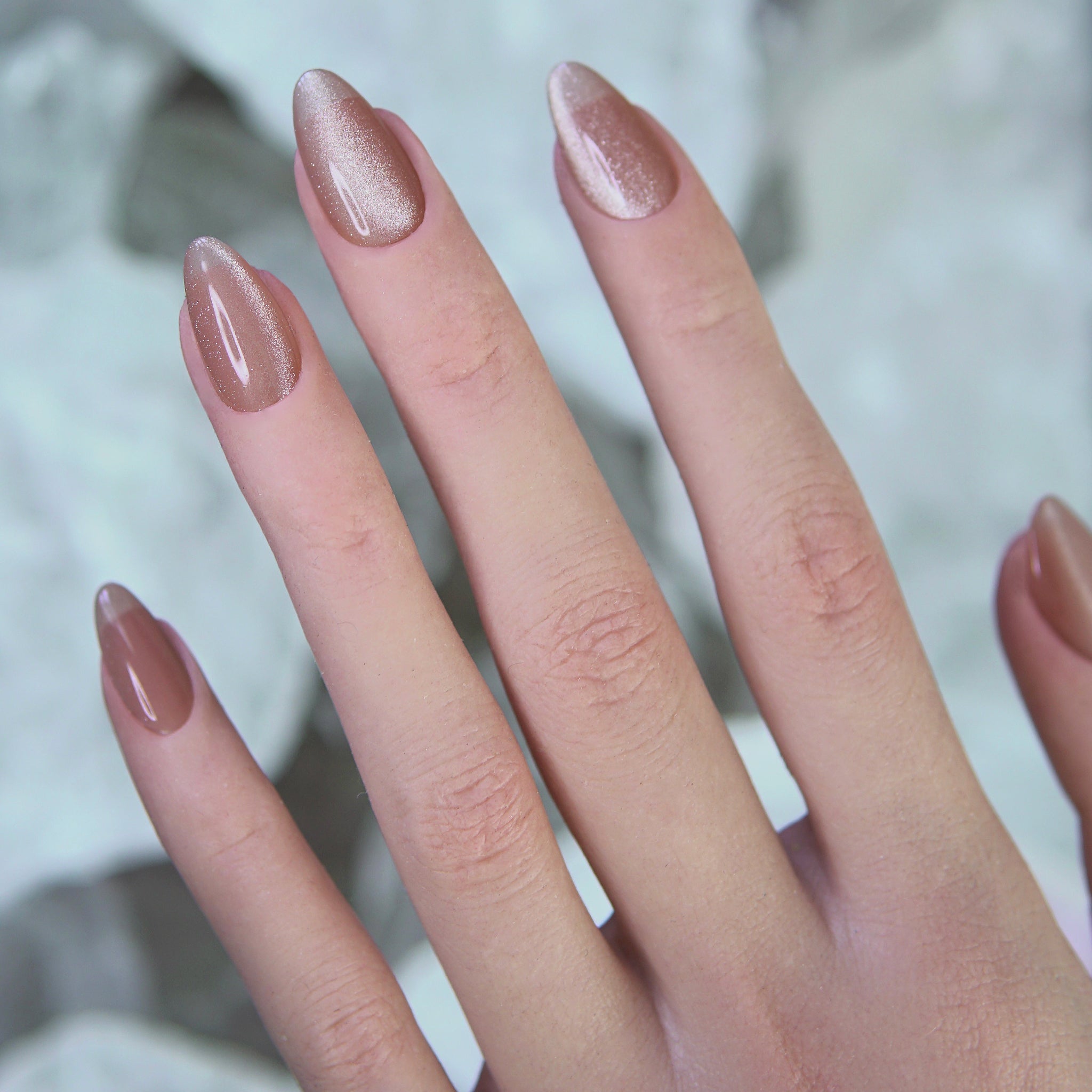 Model hand wearing Soft Base nude pink cat eye press-ons, showcasing natural fit and soft glow.

