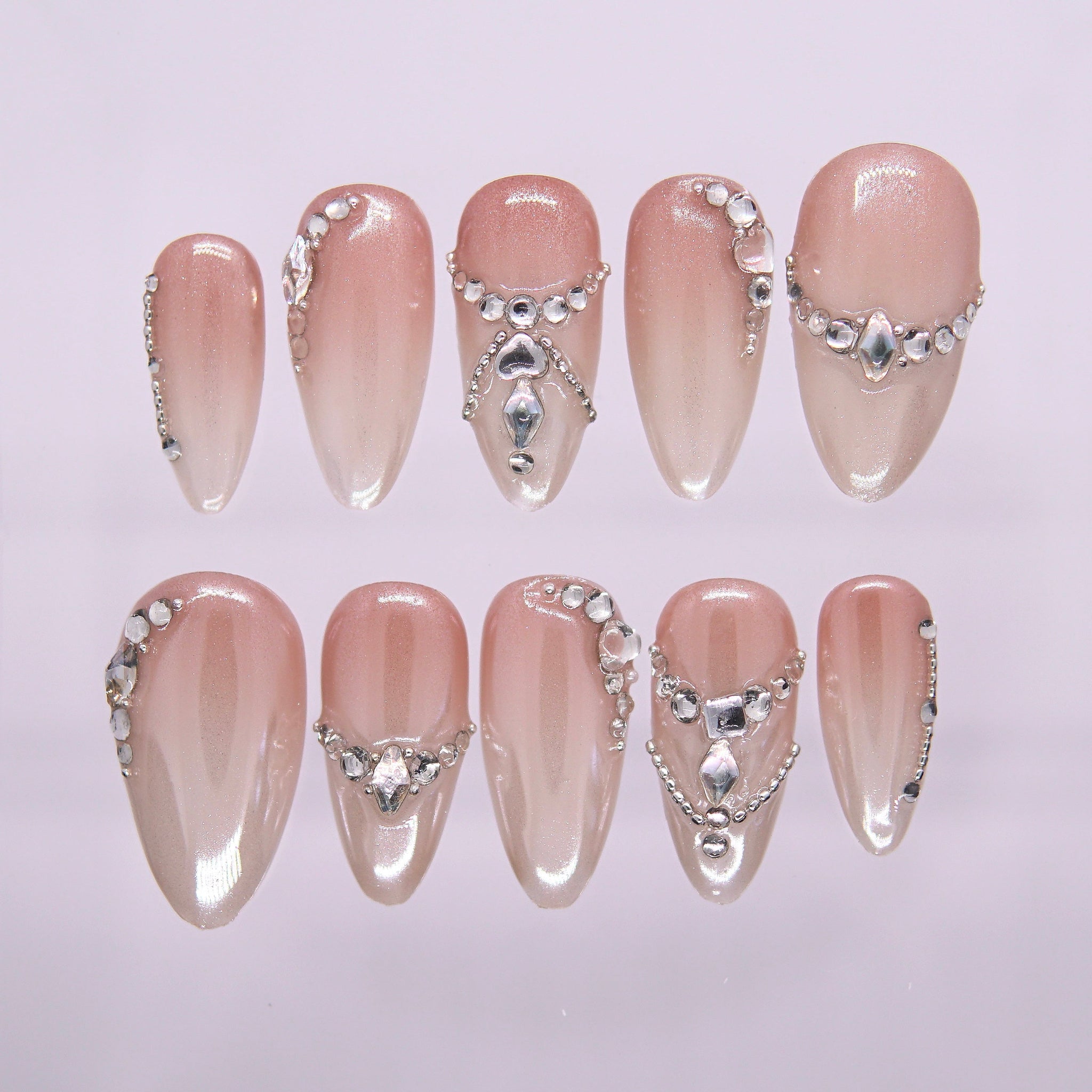 Nude almond-shaped press-on nails with silver rhinestones and glossy shimmer – Soft Power Play