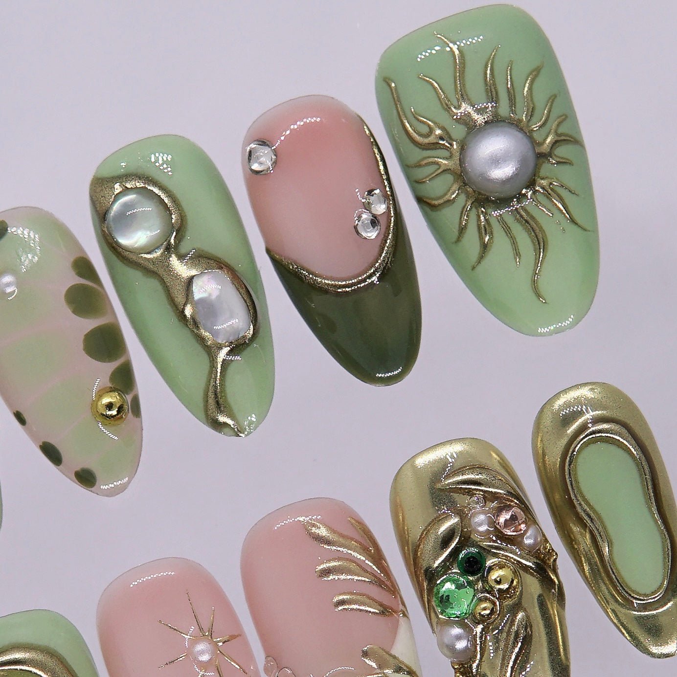 Olive green nail with gem and astrology detail.