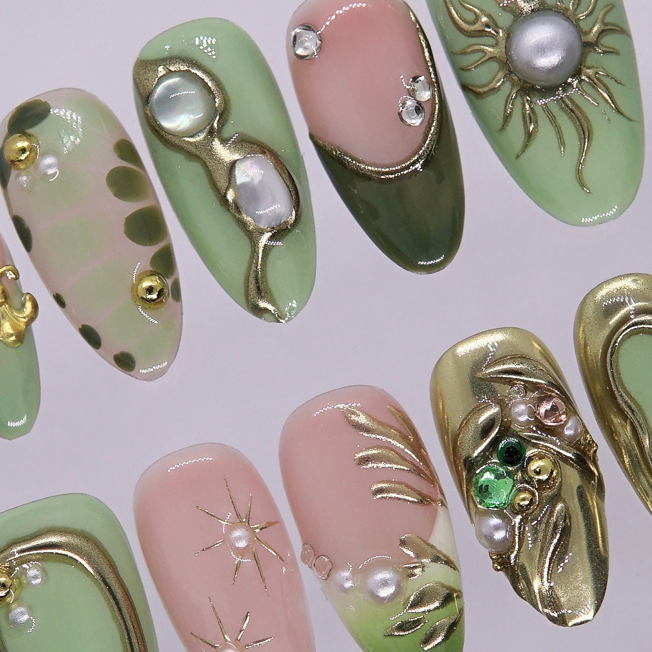 Olive green nail with gem and astrology detail.