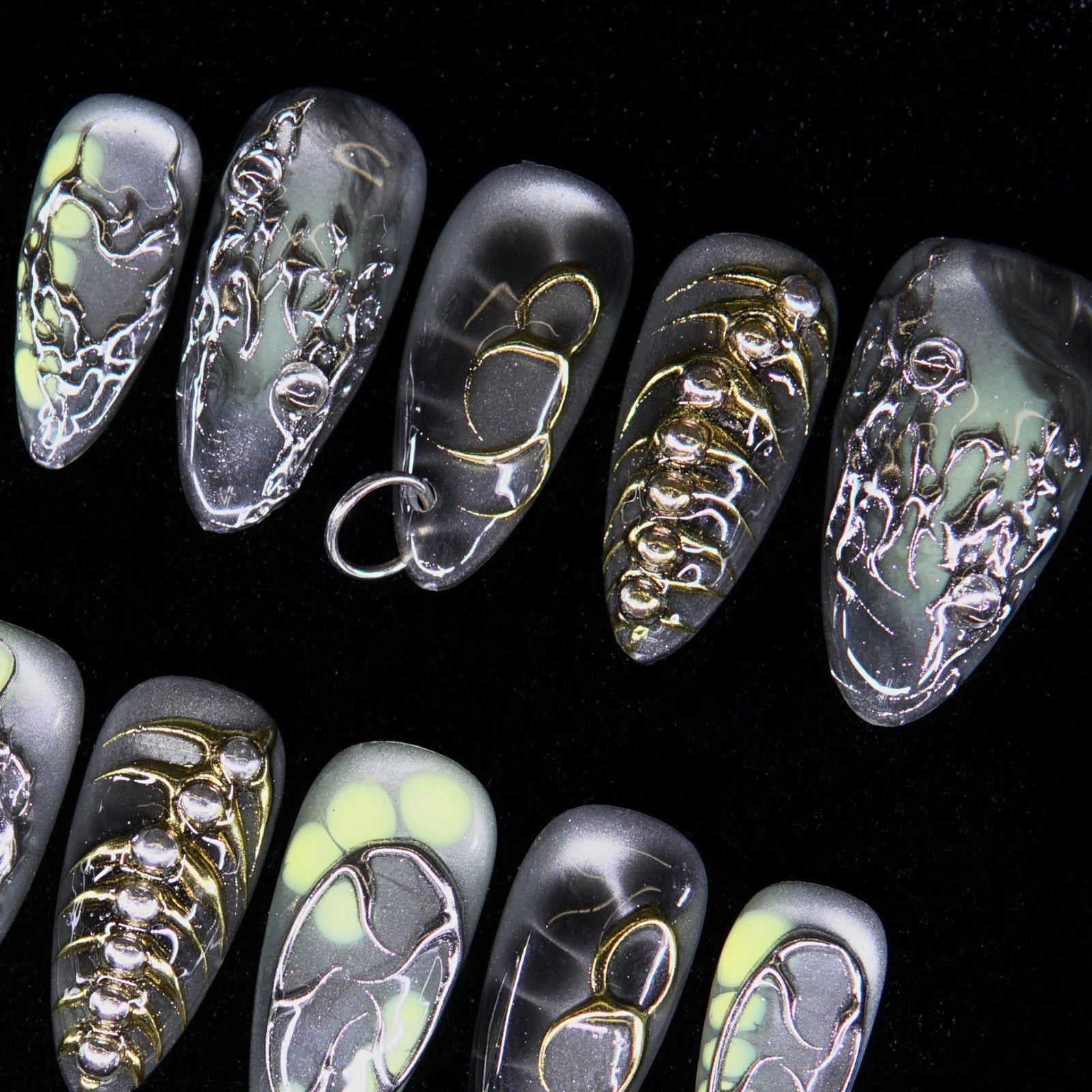 Pierced chrome heart and spine-inspired metallic detailing.