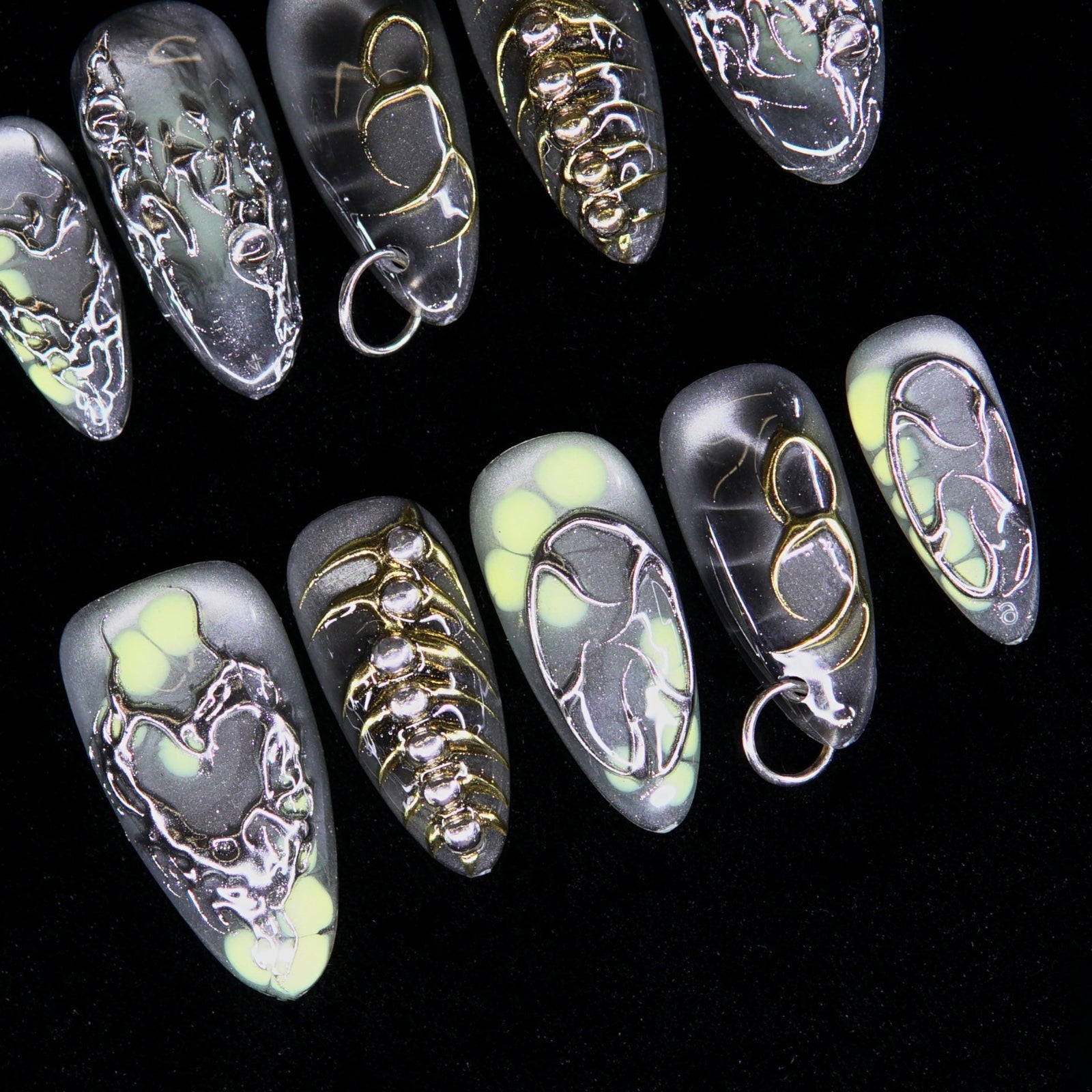 Pierced chrome heart and spine-inspired metallic detailing.