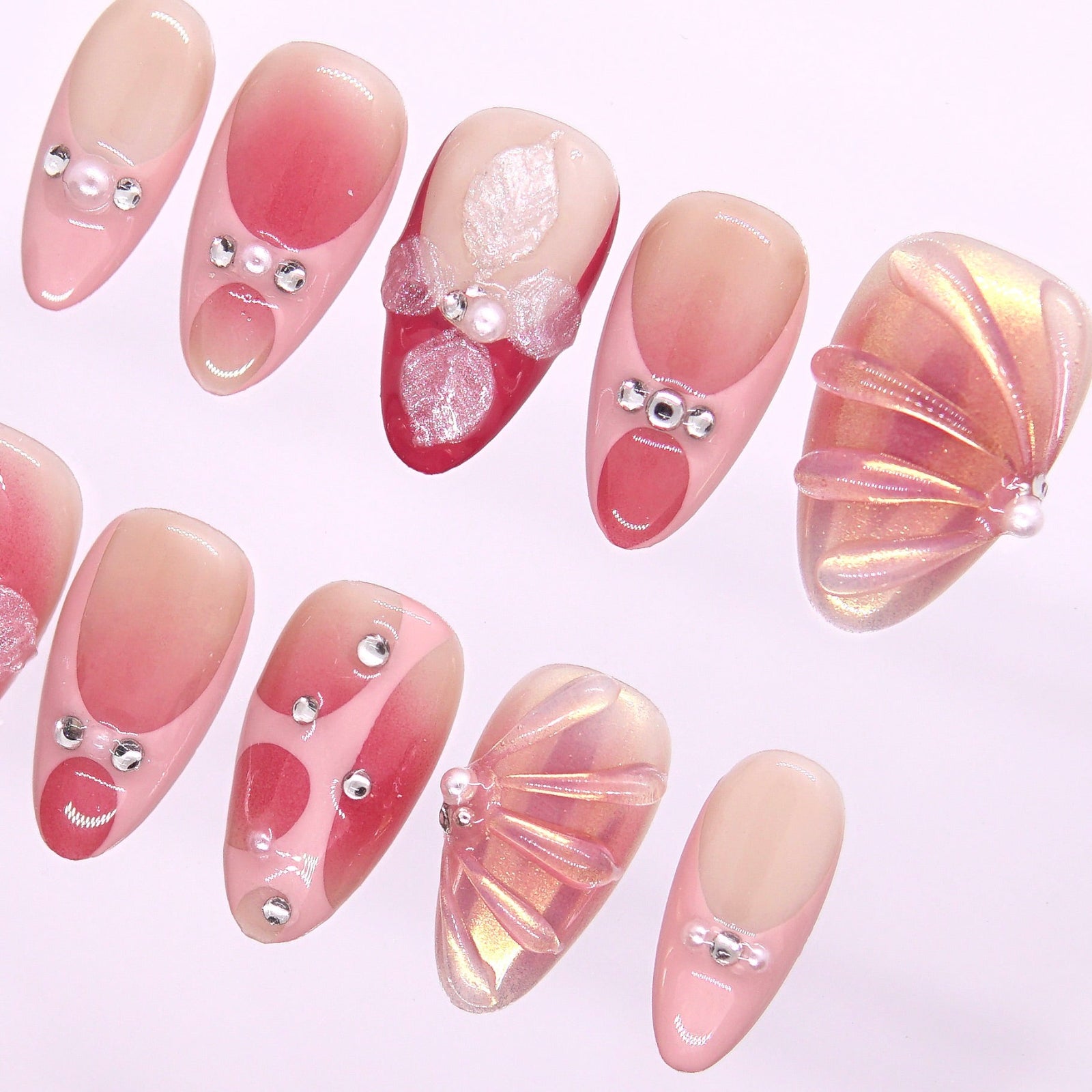 Shimmery peach-pink press-on nails with crystal accents for a soft evening glow.