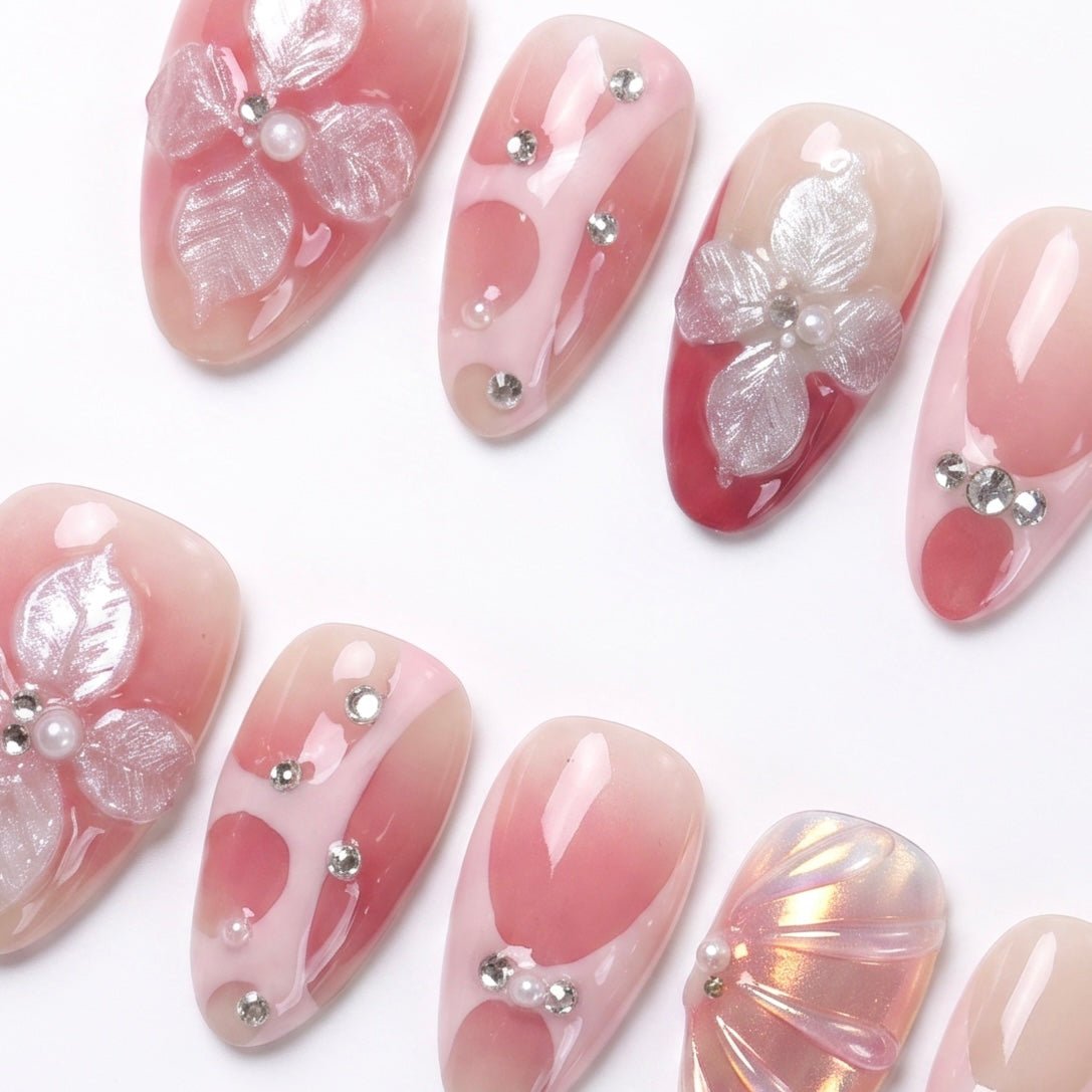 Shimmery peach-pink press-on nails with crystal accents for a soft evening glow.