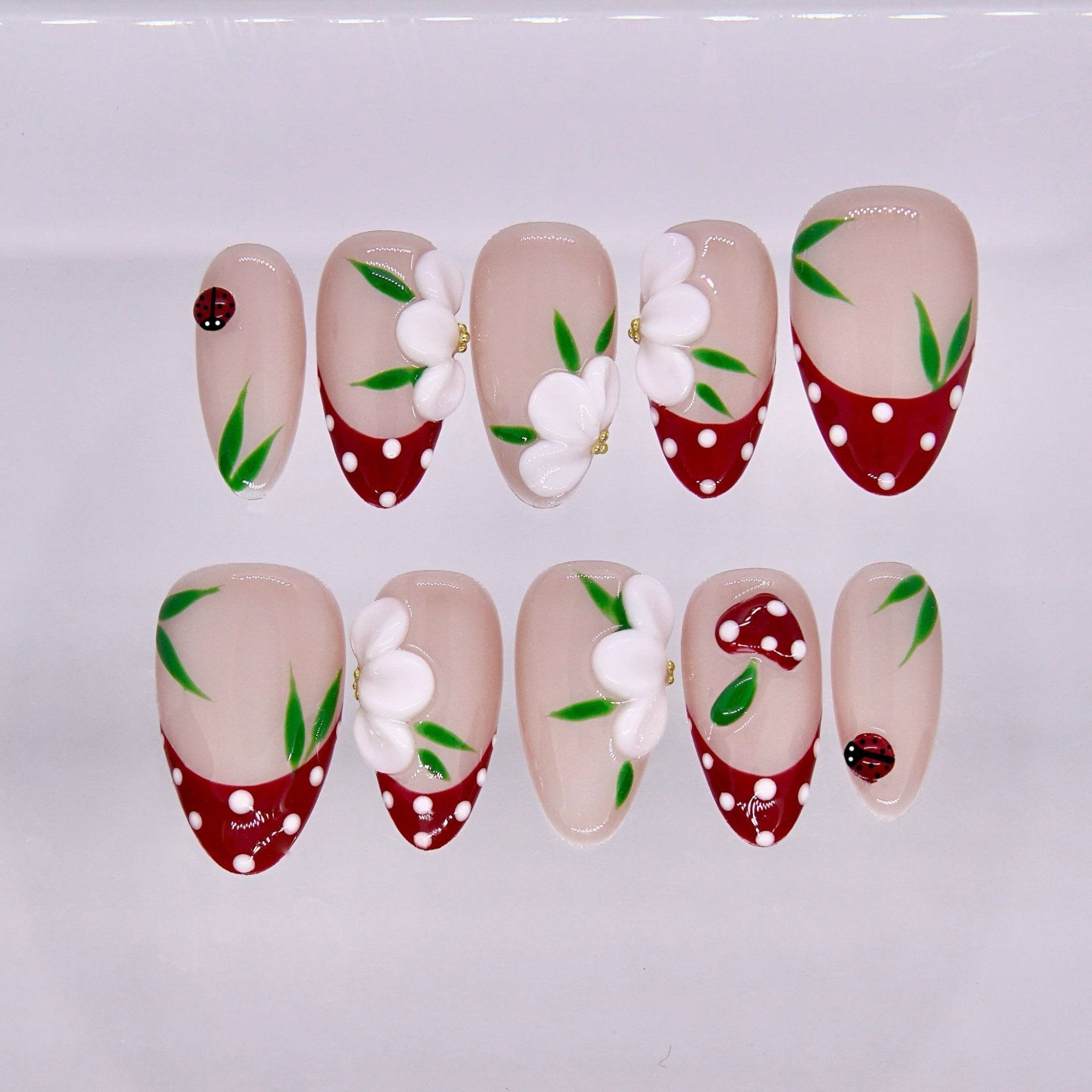 Red polka dot press on nails with floral design and playful spring details