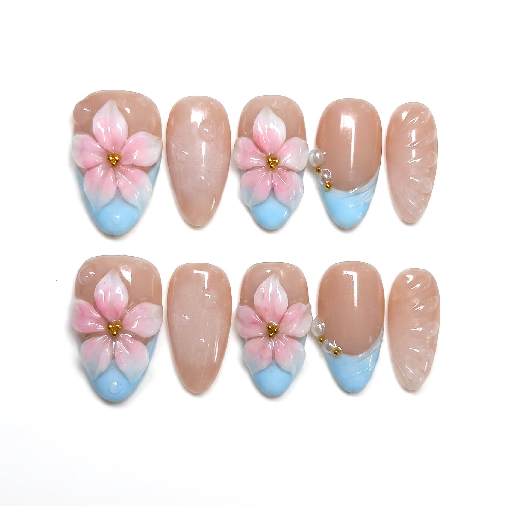 Blue French tip press on nails with 3D pink flowers and pearl embellishment.