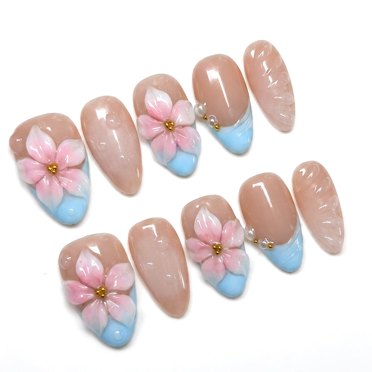 Close up of baby blue French tip with sculpted pink flower and gold bead center.
